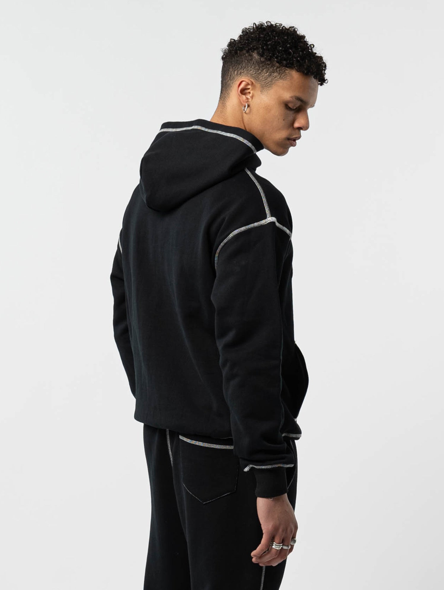 Model back view of kortsiide Superstar Stitched Triple Black Hoodies