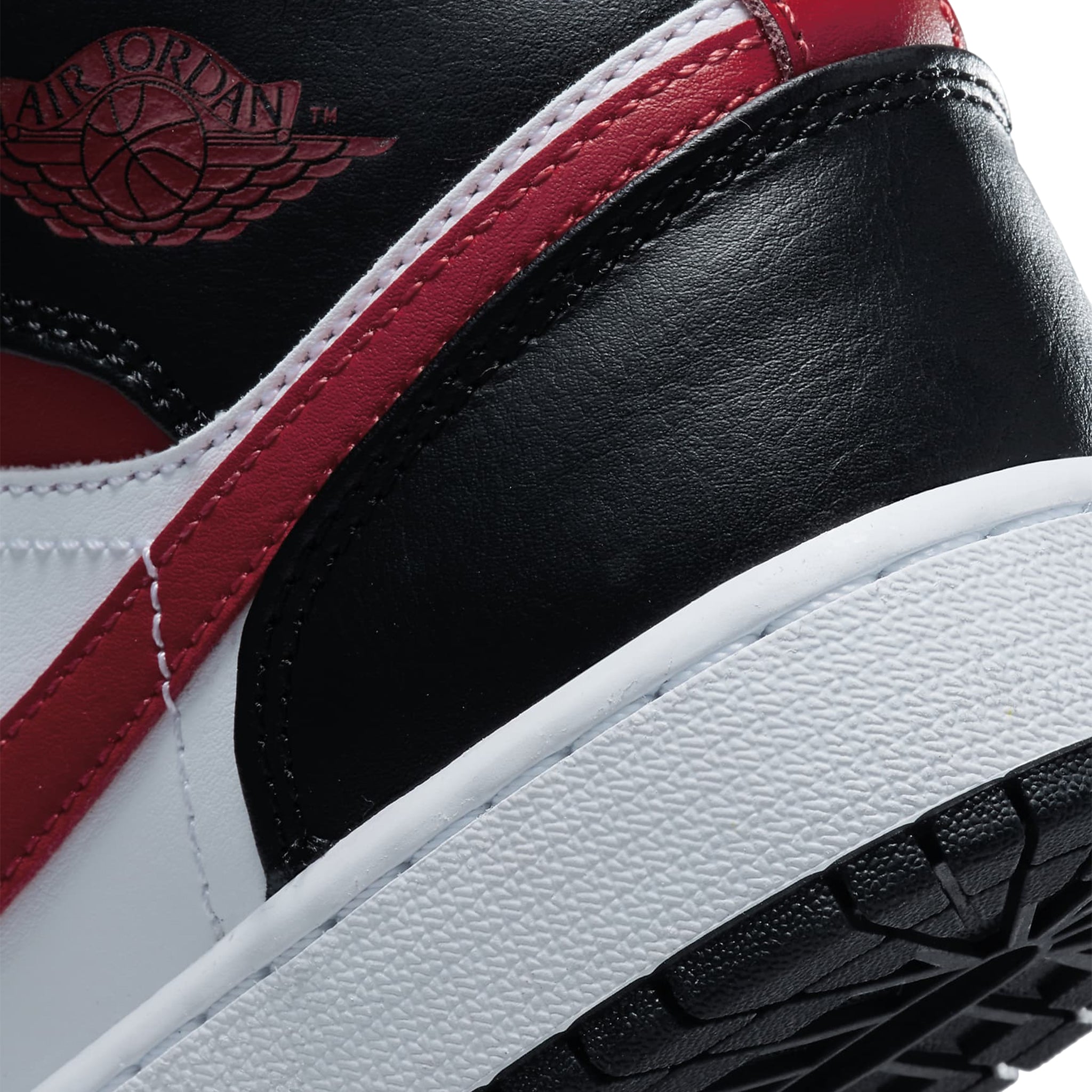 Logo view of Air Jordan 1 Mid Black Fire Red (GS) 554725-079