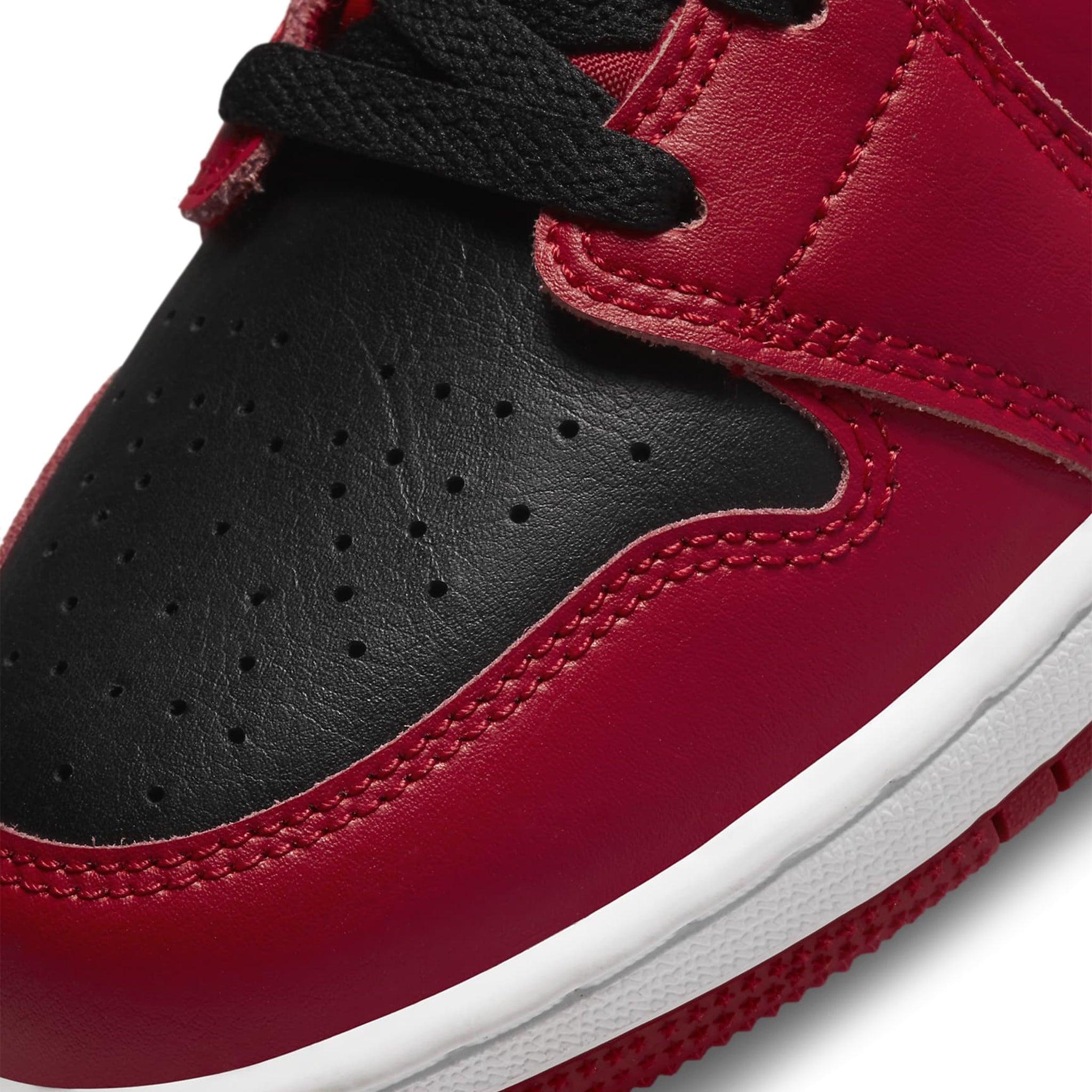 Toe box view of Air Jordan 1 Mid Reverse Bred (GS) 554725-660