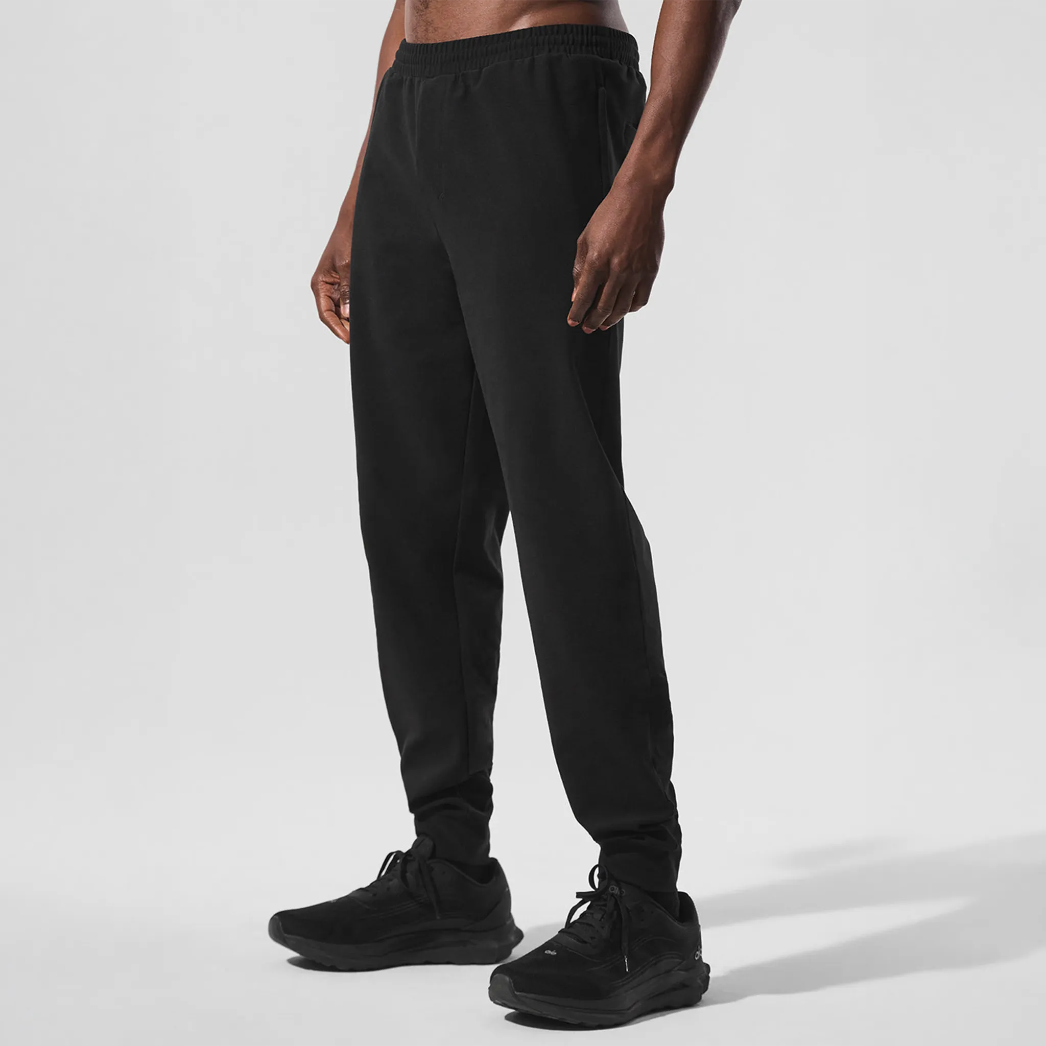 Front Side View of Alo Yoga Conquer Max Performance Black Sweatpants