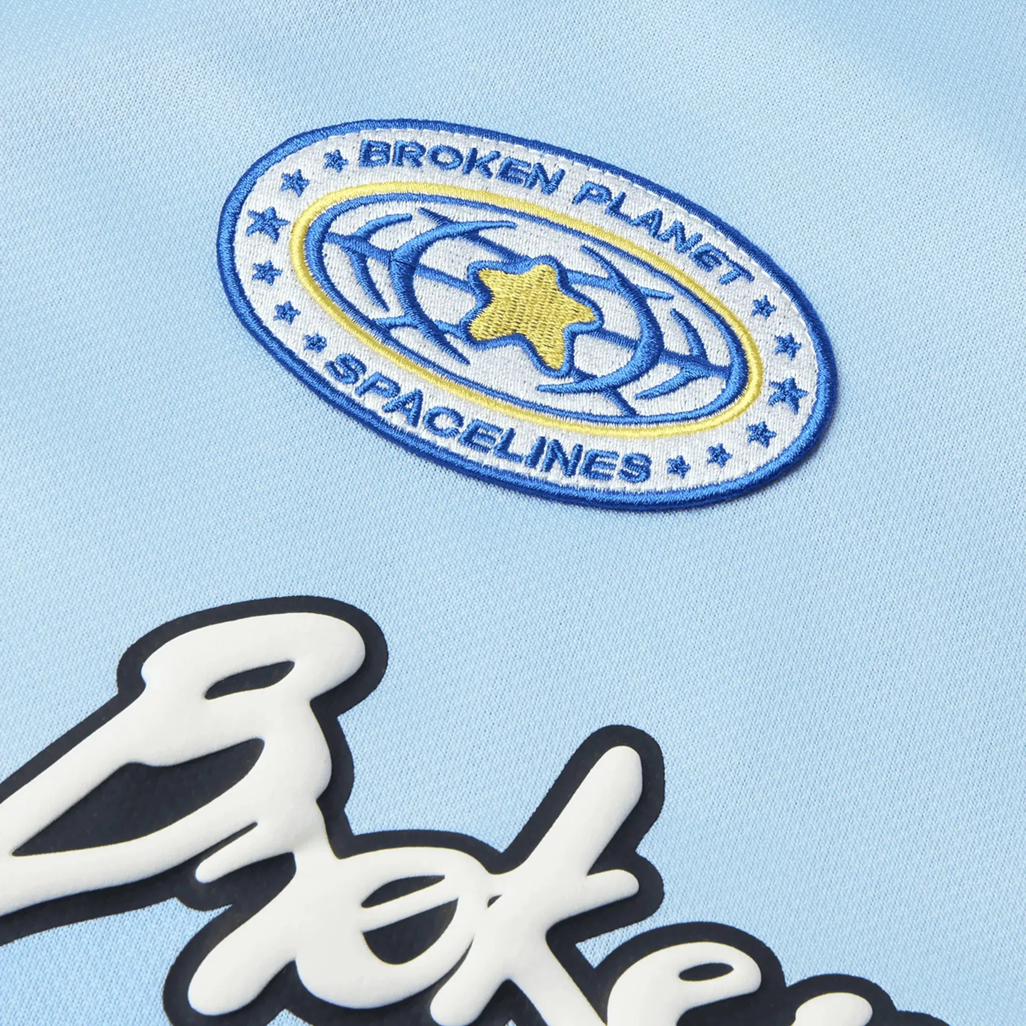 Detail view of Broken Planet Light Blue Football Jersey