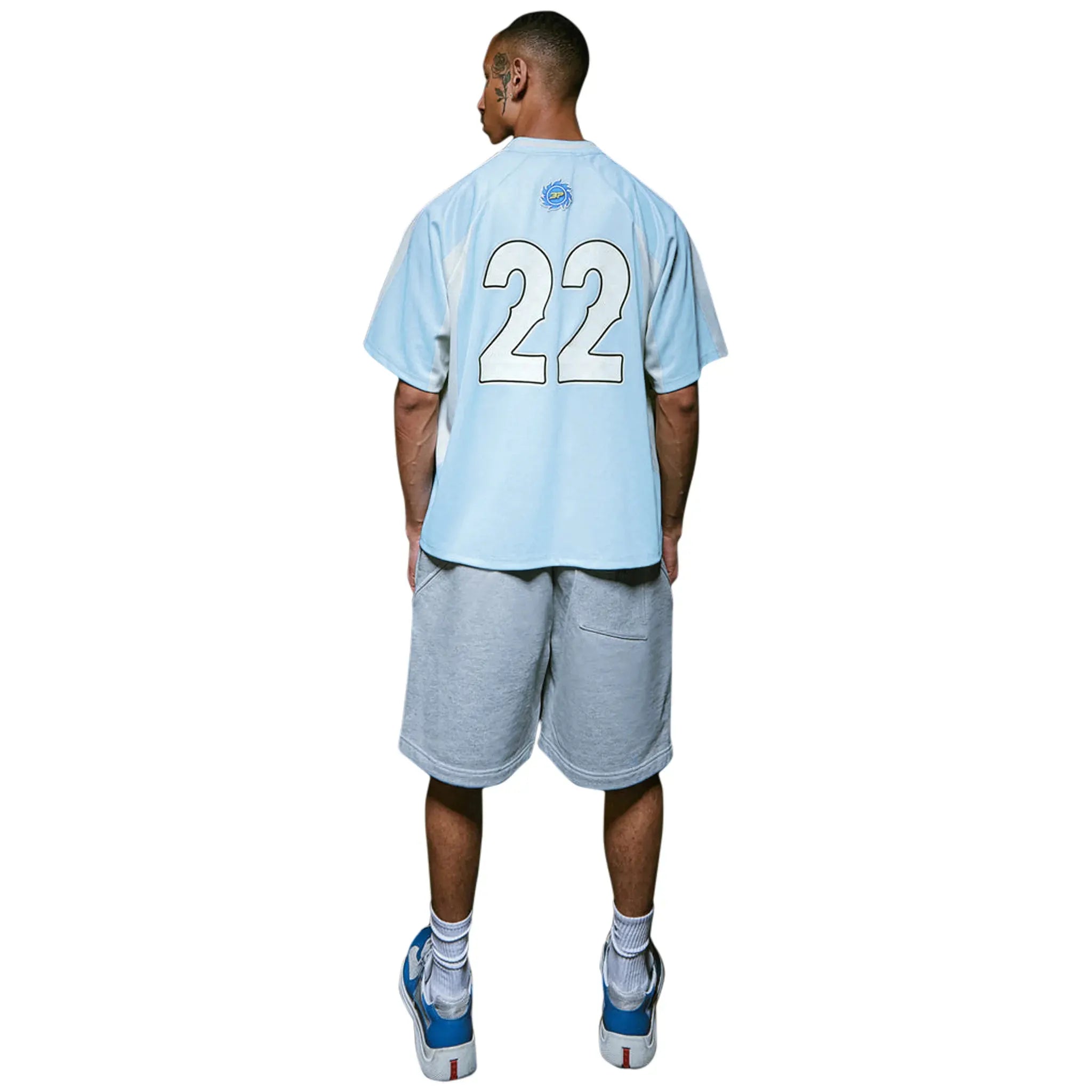 Model back view of Broken Planet Light Blue Football Jersey