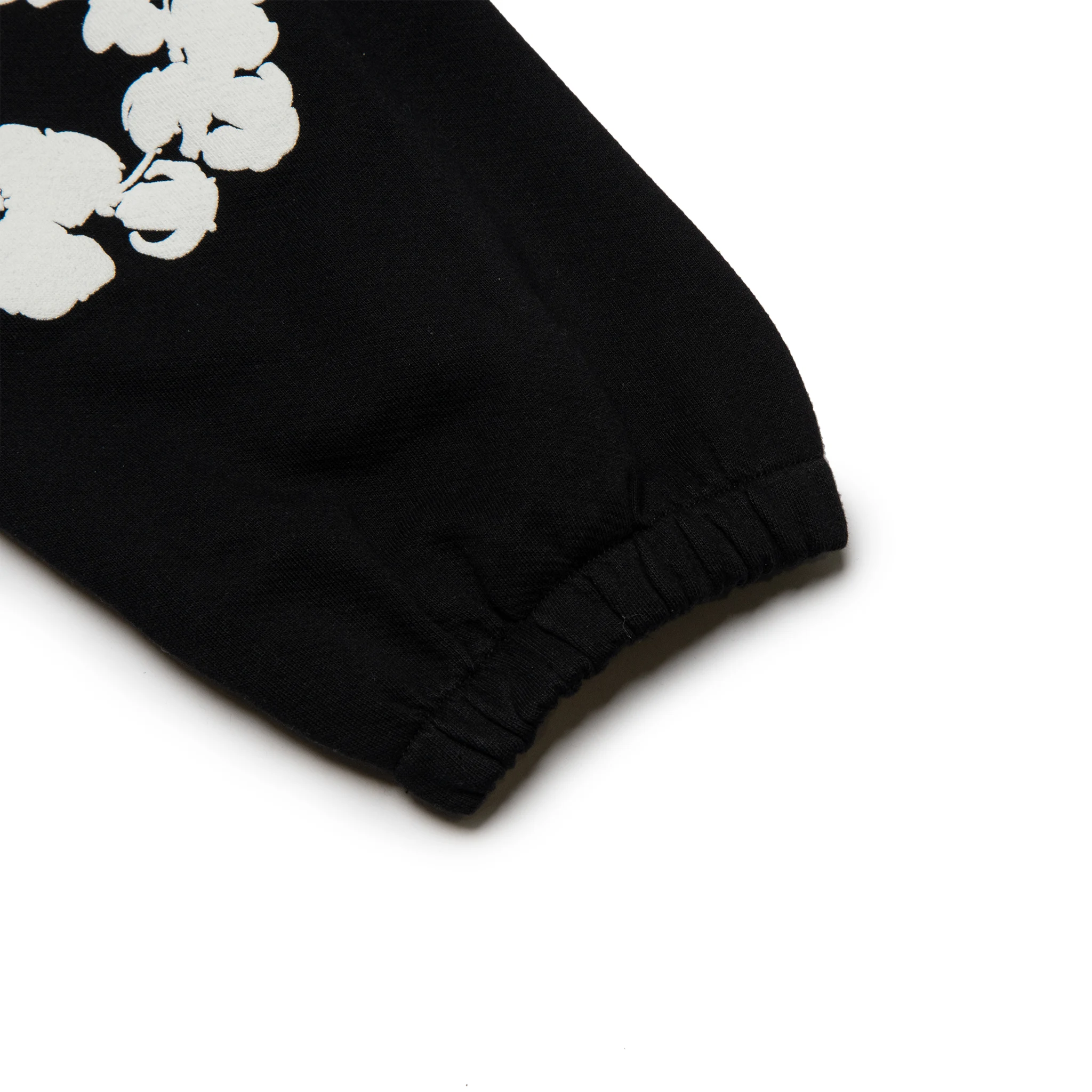 Leg view of Denim Tears The Cotton Wreath Black Sweatpants