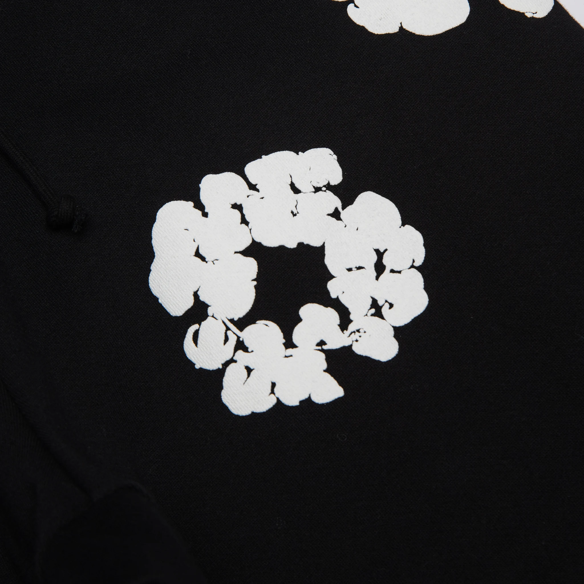 Detail view of Denim Tears The Cotton Wreath Black Sweatpants