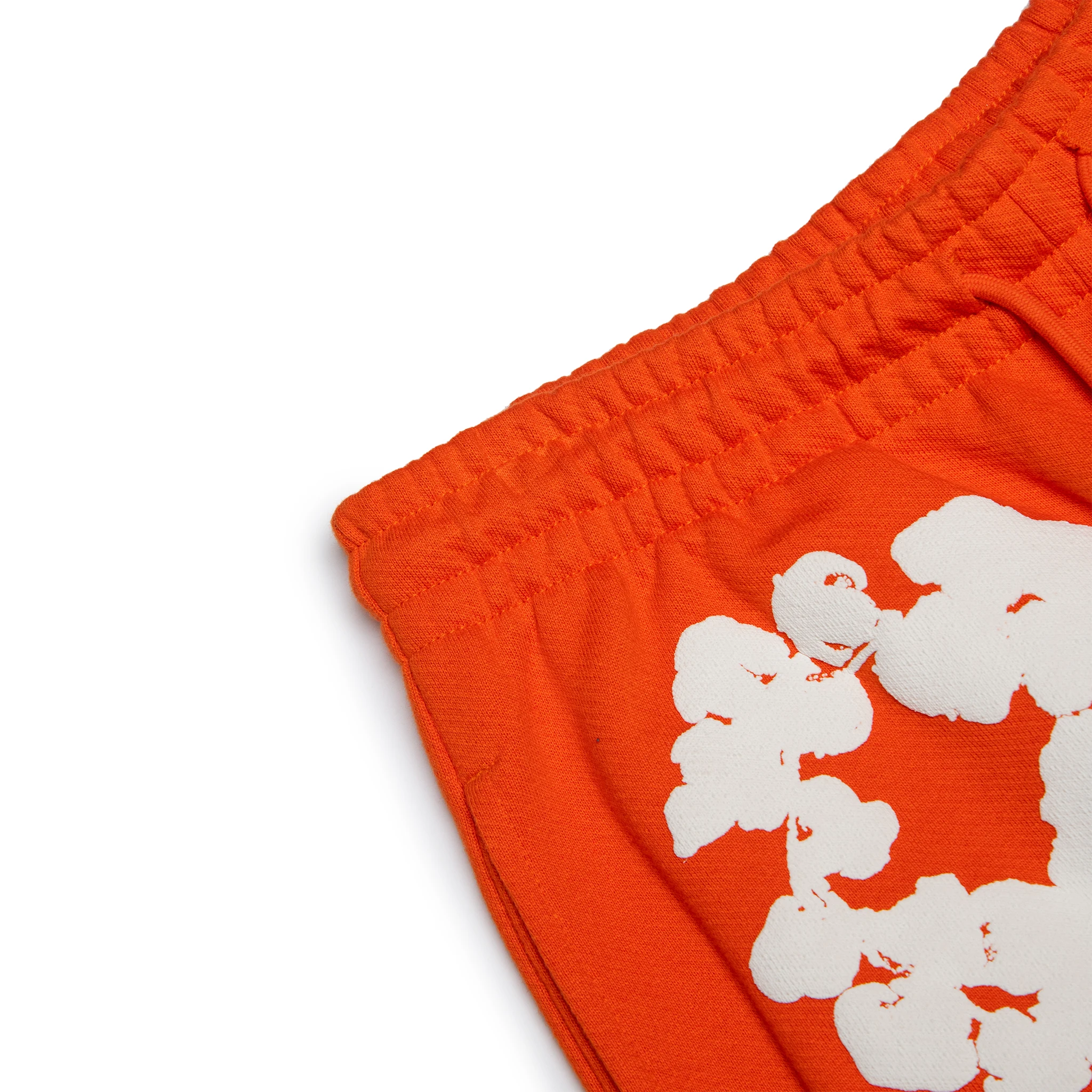 Corner view of Denim Tears The Cotton Wreath Orange Sweatpants