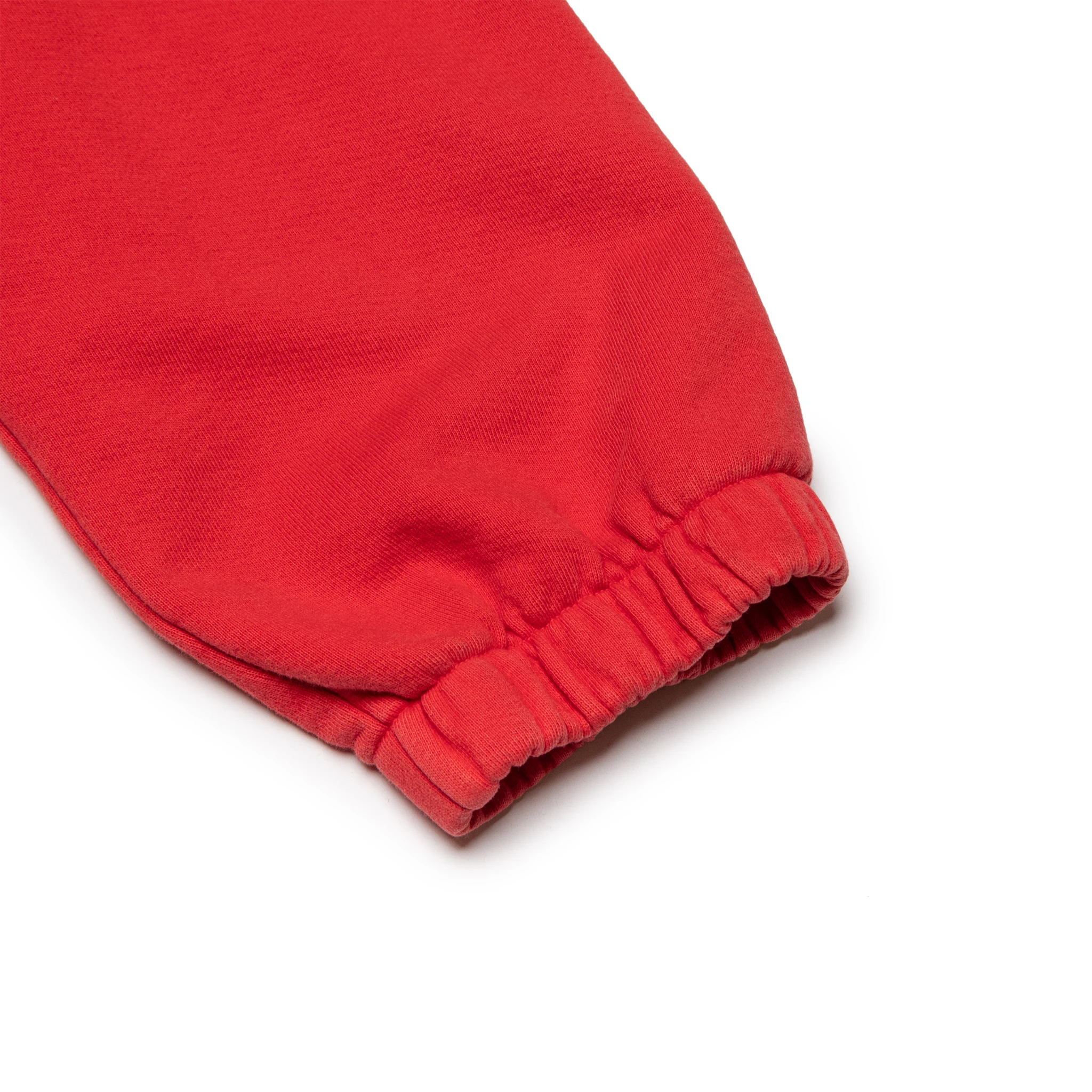 Leg view of Denim Tears University Red Sweatpants