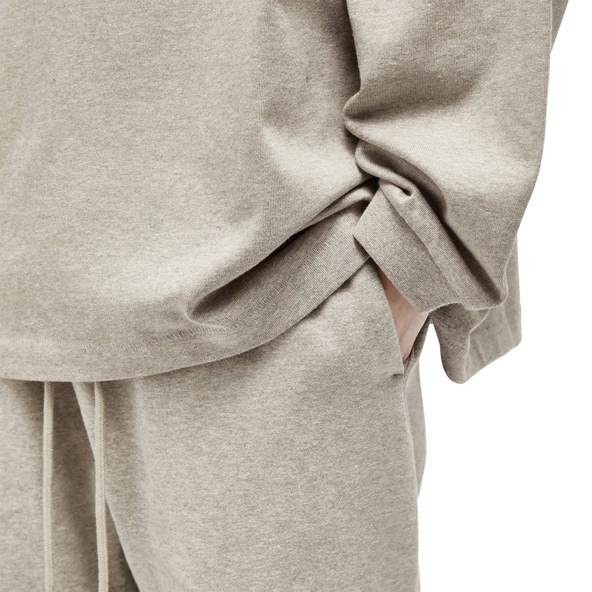 Detailed View of Model Front Side View of Fear Of God Essentials Core Collection Dark Heather Oatmeal Sweatpants (FW23) 130SP242023F