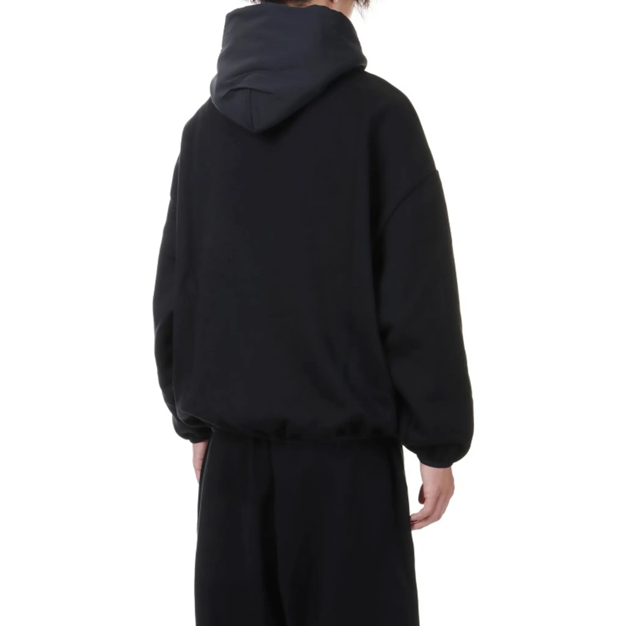 Model Back View of Fear Of God Essentials Core Collection Nylon Fleece Black Hoodie (SS24) 202SU244310F