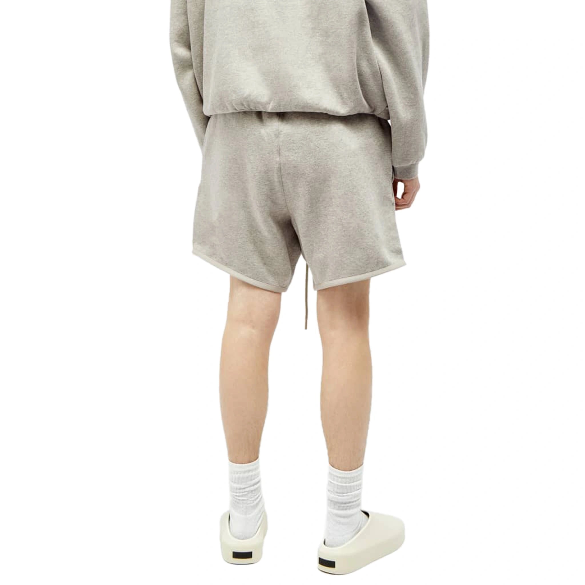 Model back view of Fear Of God Essentials Dark Heather Oatmeal Shorts (FW23) 160SP242003F