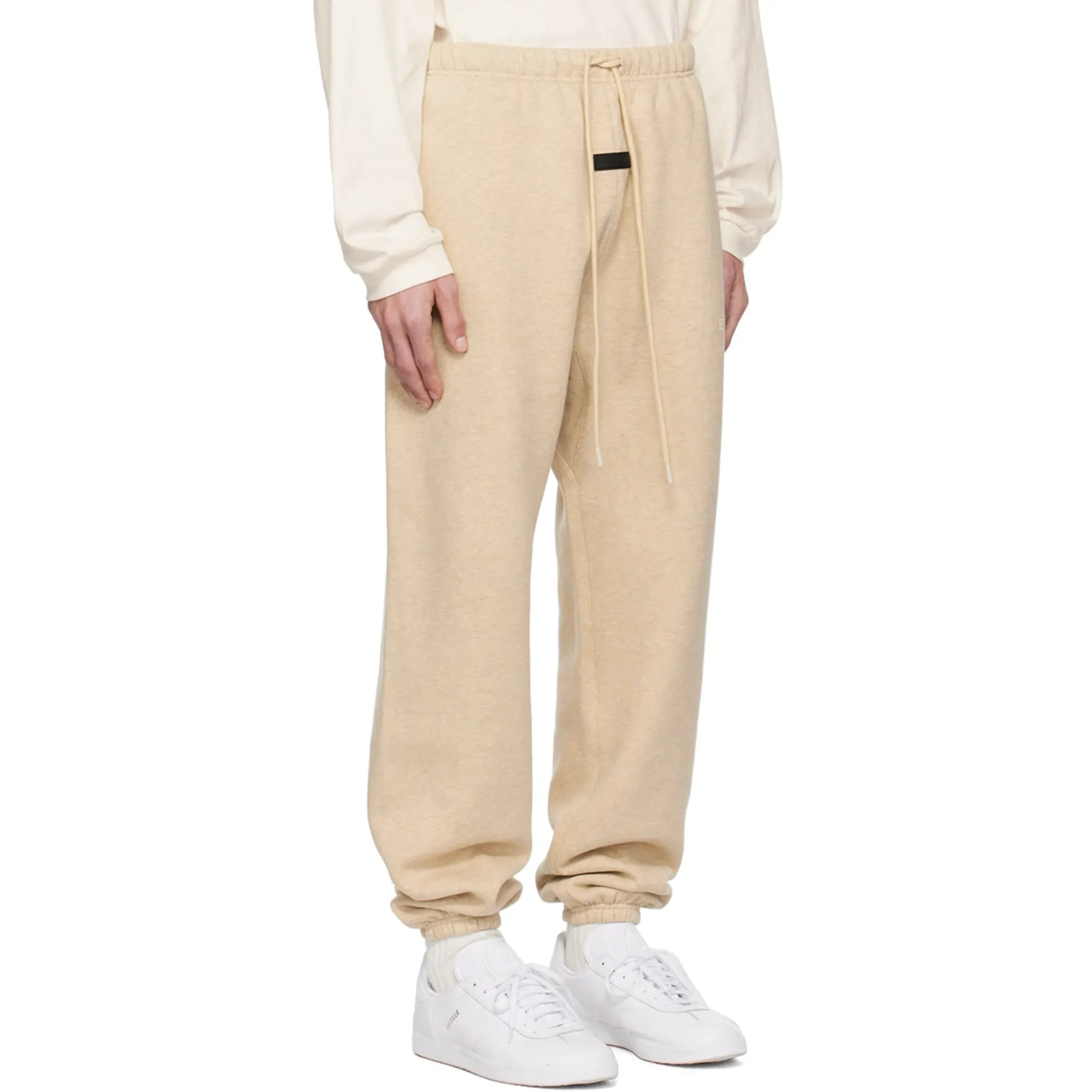 Model side view of Fear Of God Essentials Gold Heather Sweatpants (FW23)