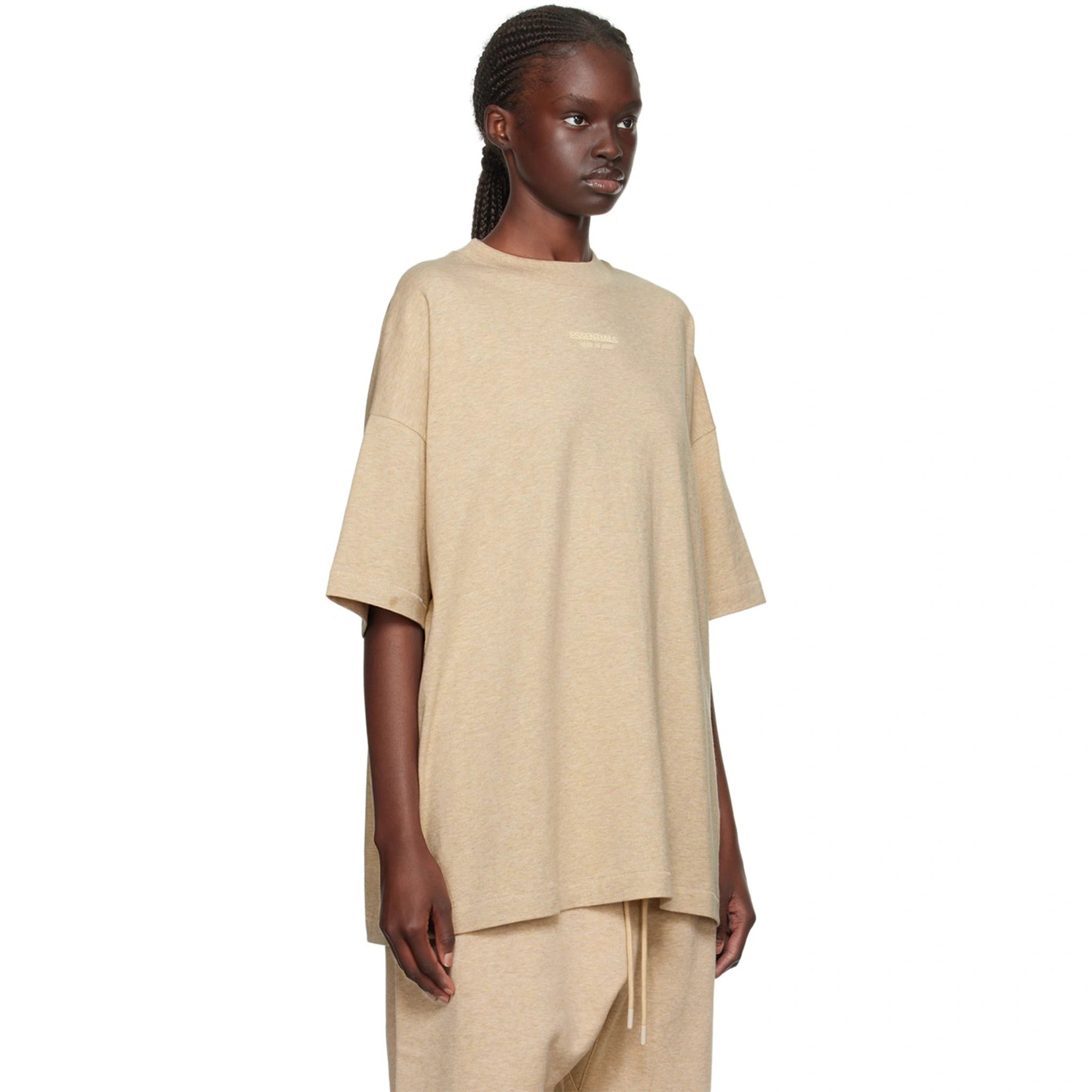 Model side view of Fear Of God Essentials Gold Heather T Shirt (FW23) 125BT232003F