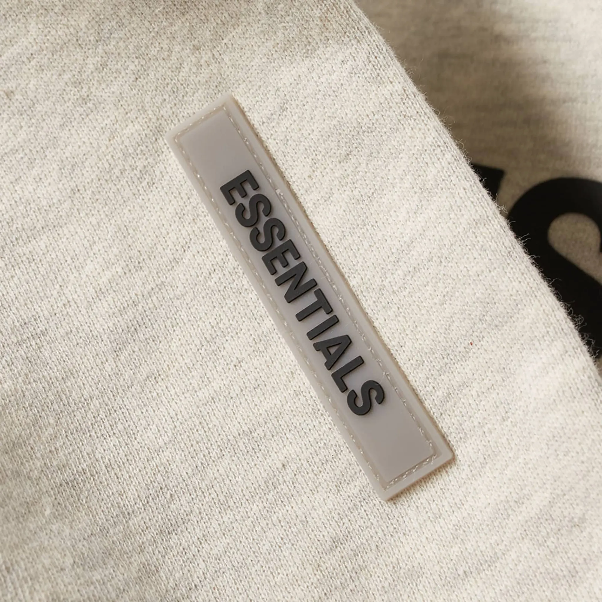 Detail view of Fear Of God Essentials Oatmeal Hoodie
