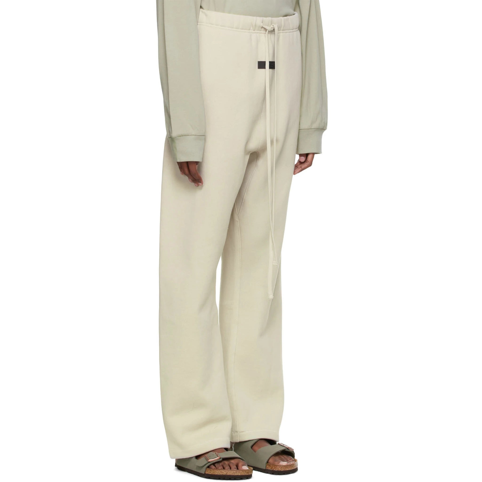 Model side view of Fear Of God Essentials Relaxed Wheat Sweatpants (SS22) 130BT212047F