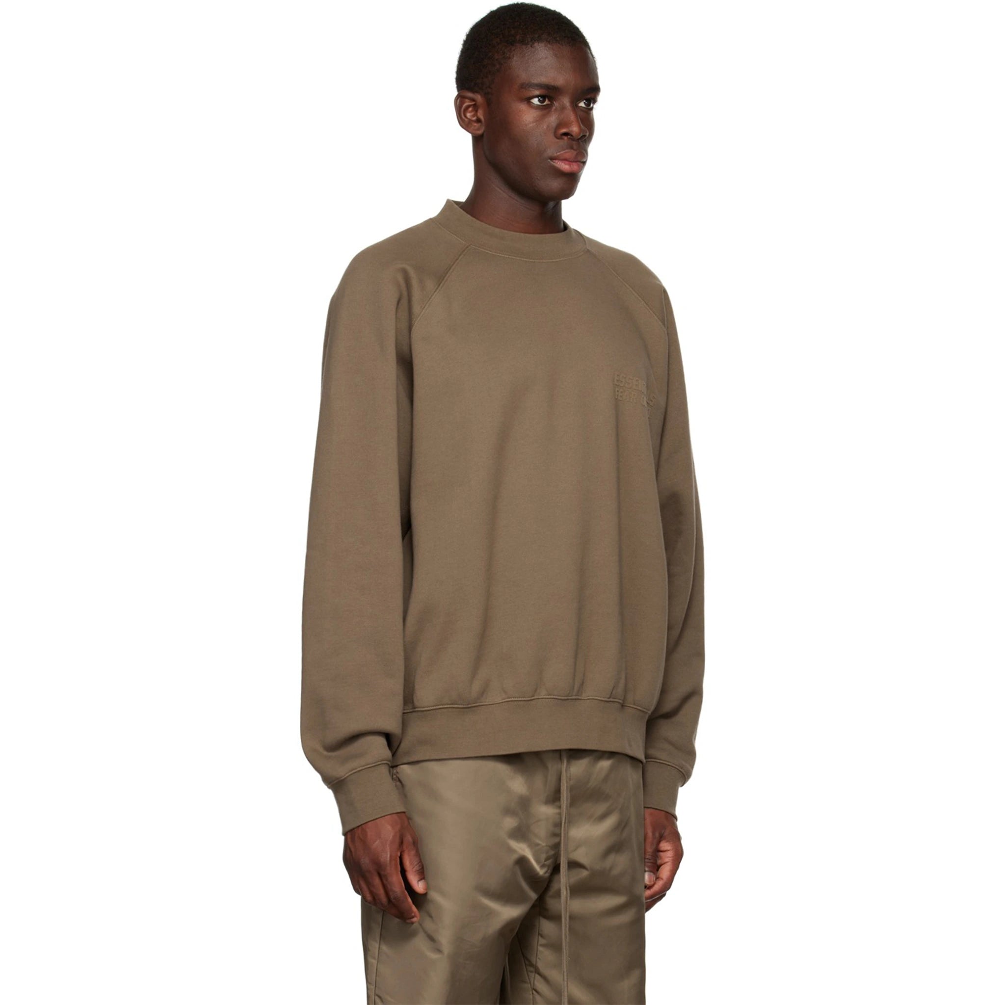 Model side view of Fear Of God Essentials Wood Crewneck (FW22)