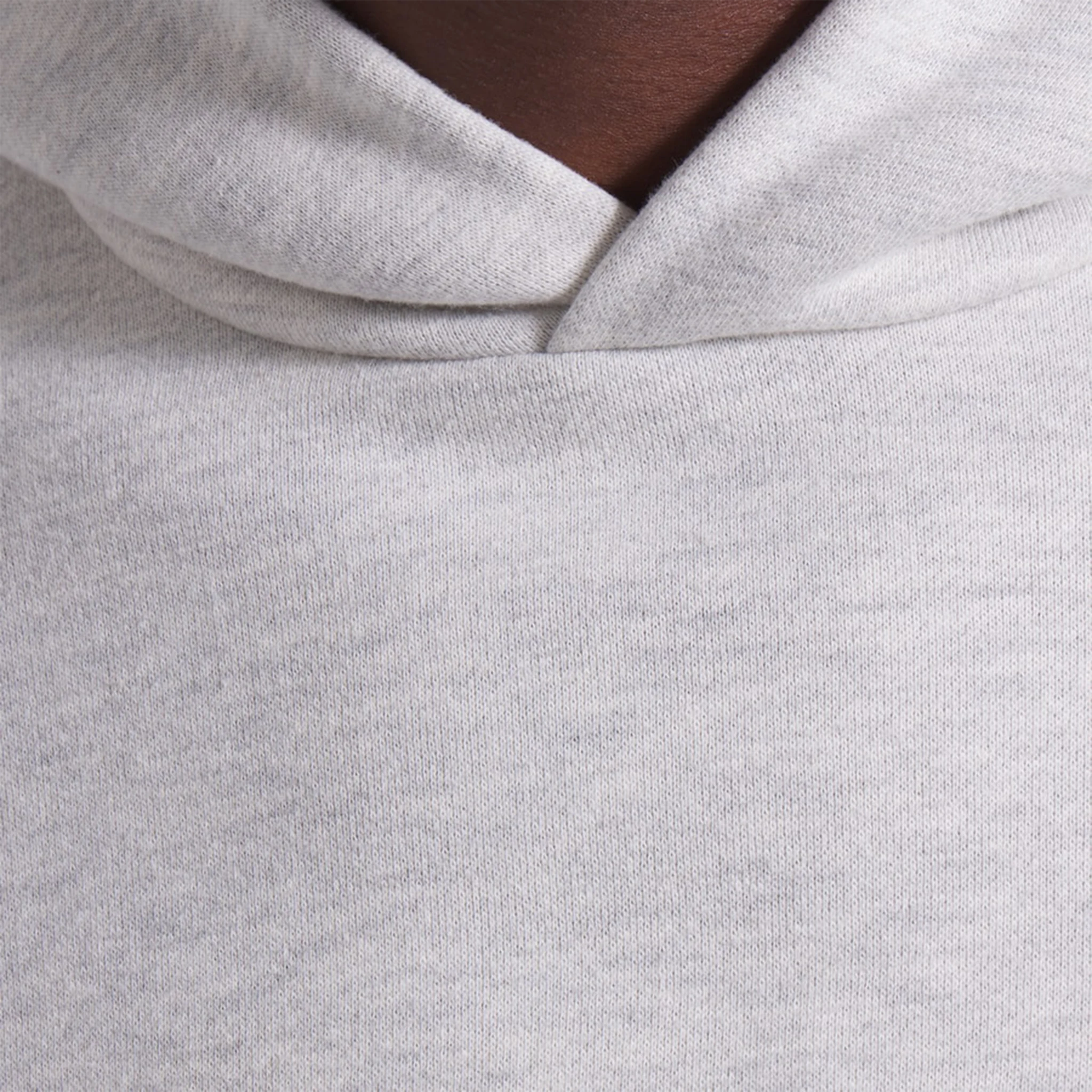 Model neck view of Fear Of God Essentials x NBA Light Heather Hoodie 192AL246400F