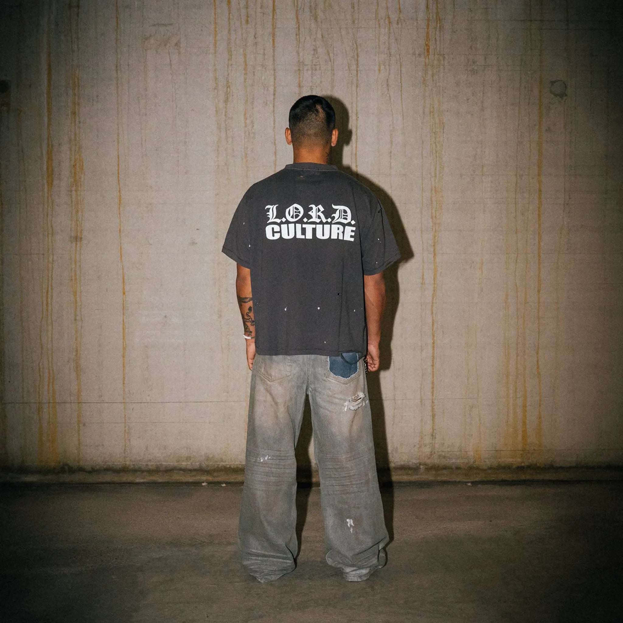 Model Back View of Lord Culture Raider Washed Grey Brown T-Shirt