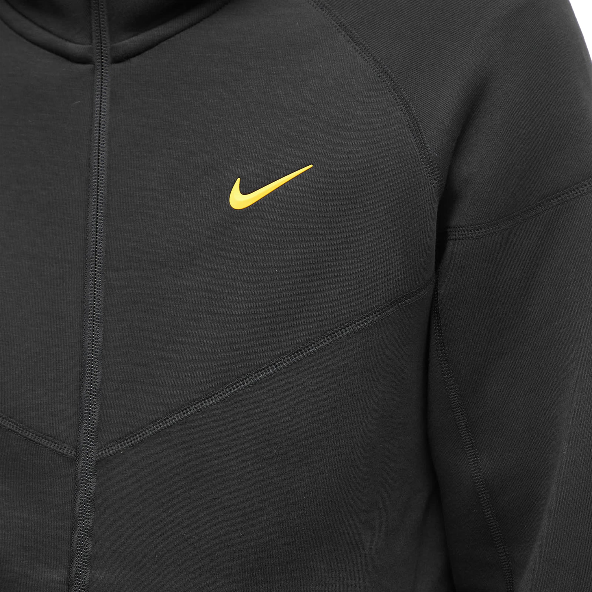 Model logo view of nike x nocta tech fleece black zip-up hoodie fd8453-010