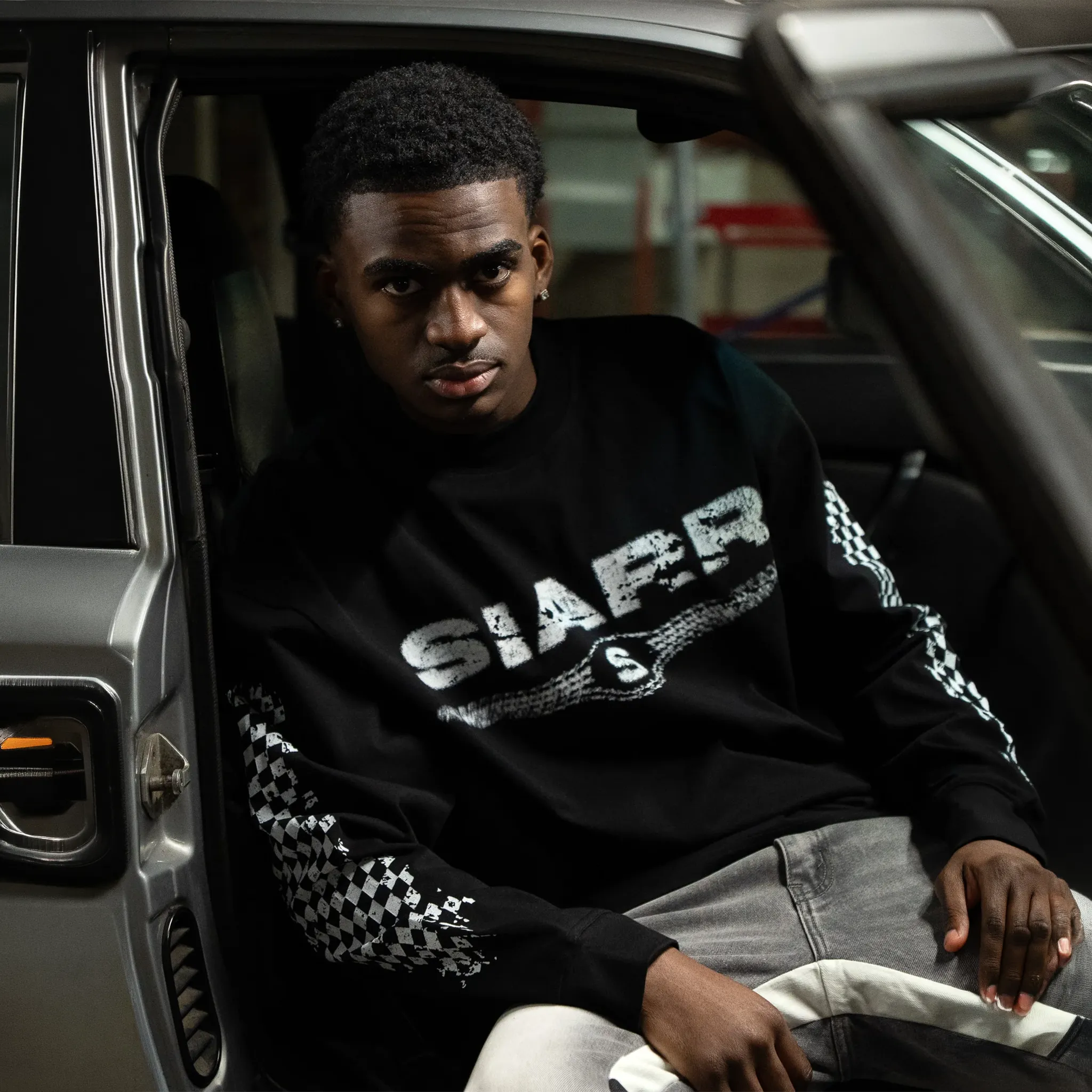Model Front View of SIARR Chequered L/S Black T-Shirt