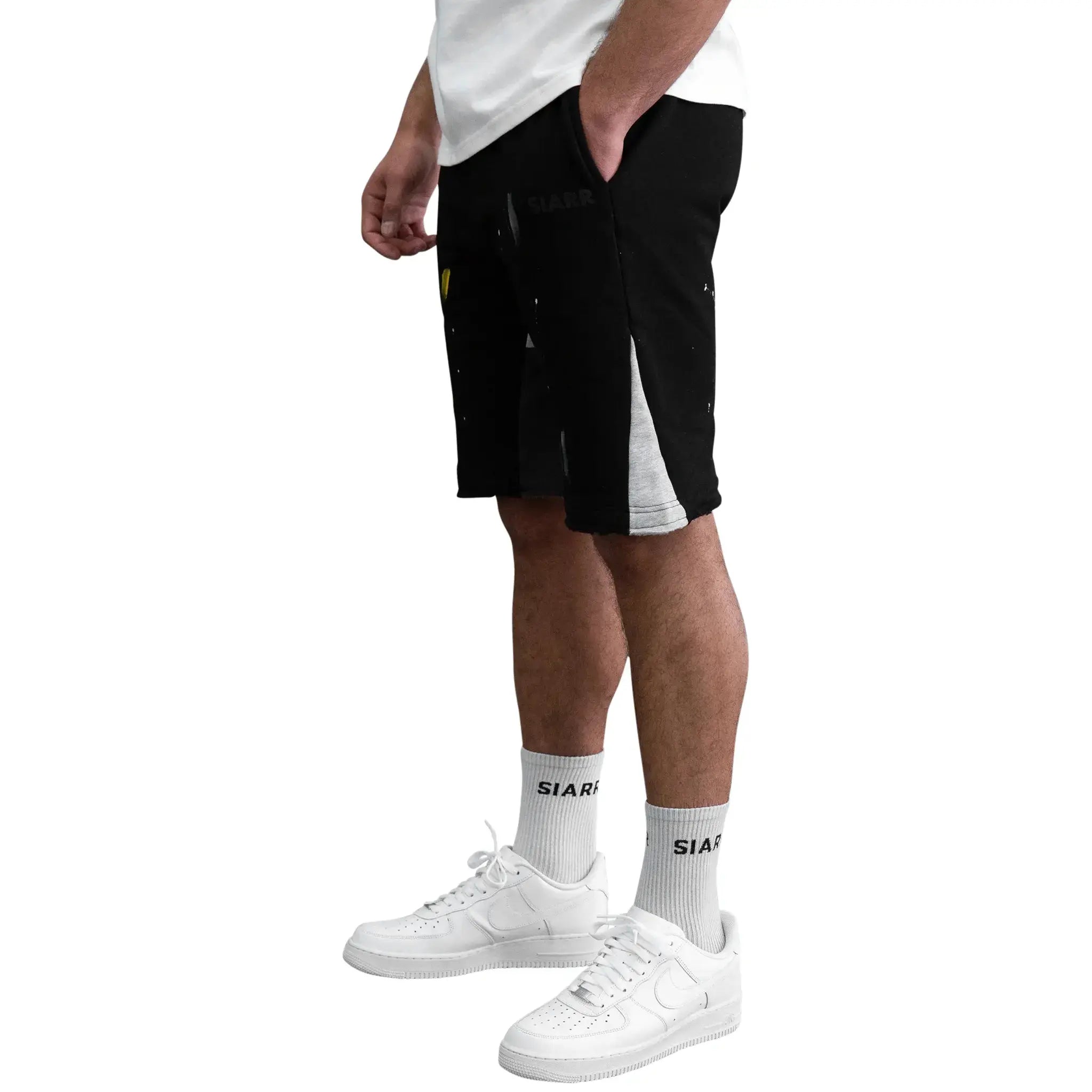 Model side view of SIARR Paint Shorts Black