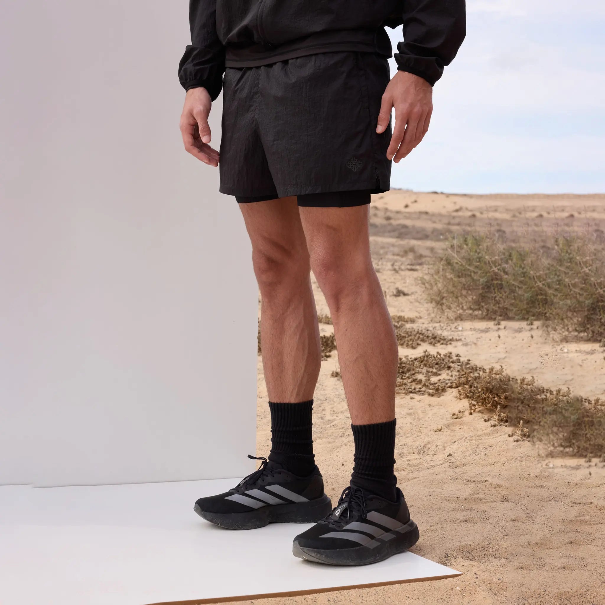 Front Side View of Couture Club 2 in 1 Translucent Run Black Shorts