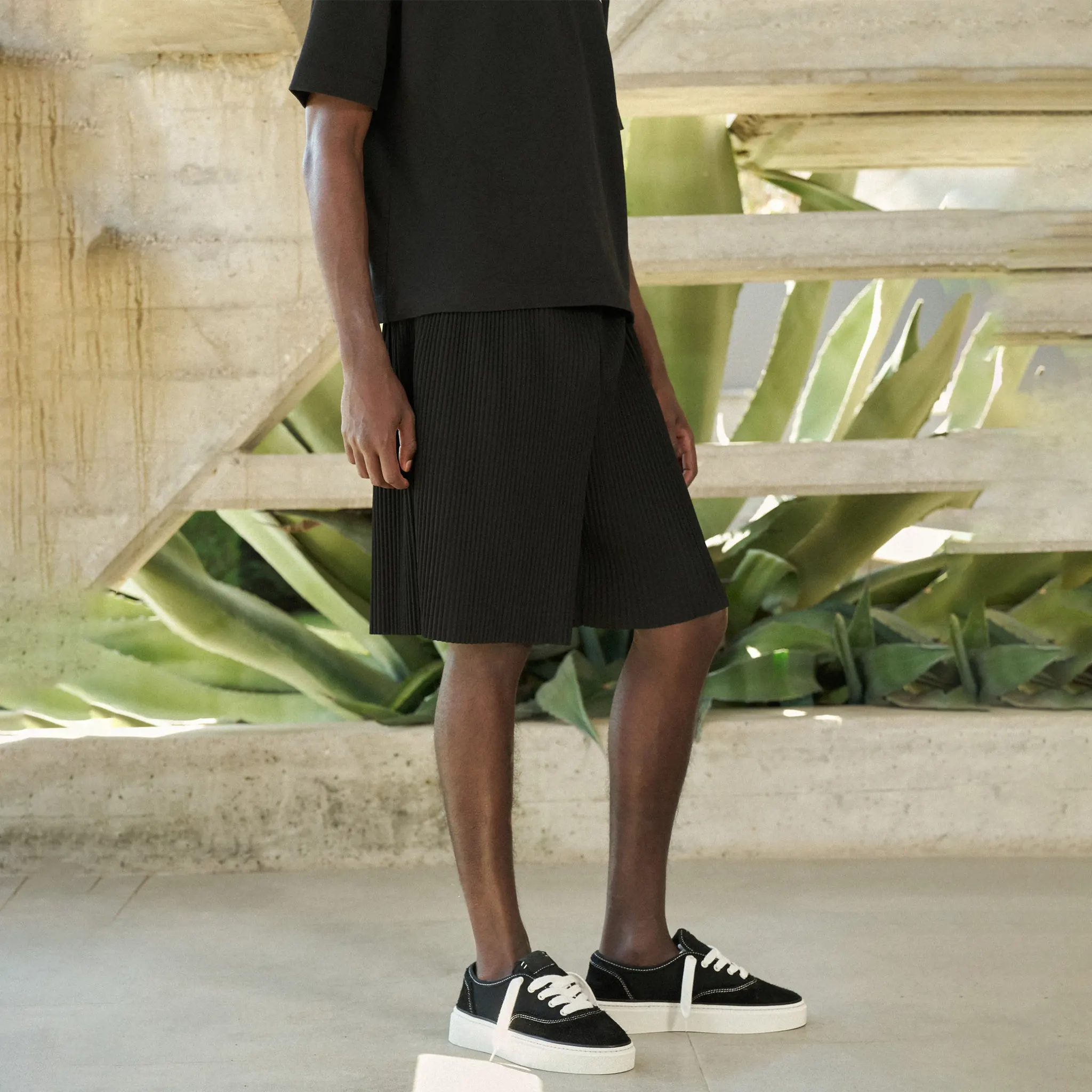 Front Side View of The Couture Club Plisse Black Shorts