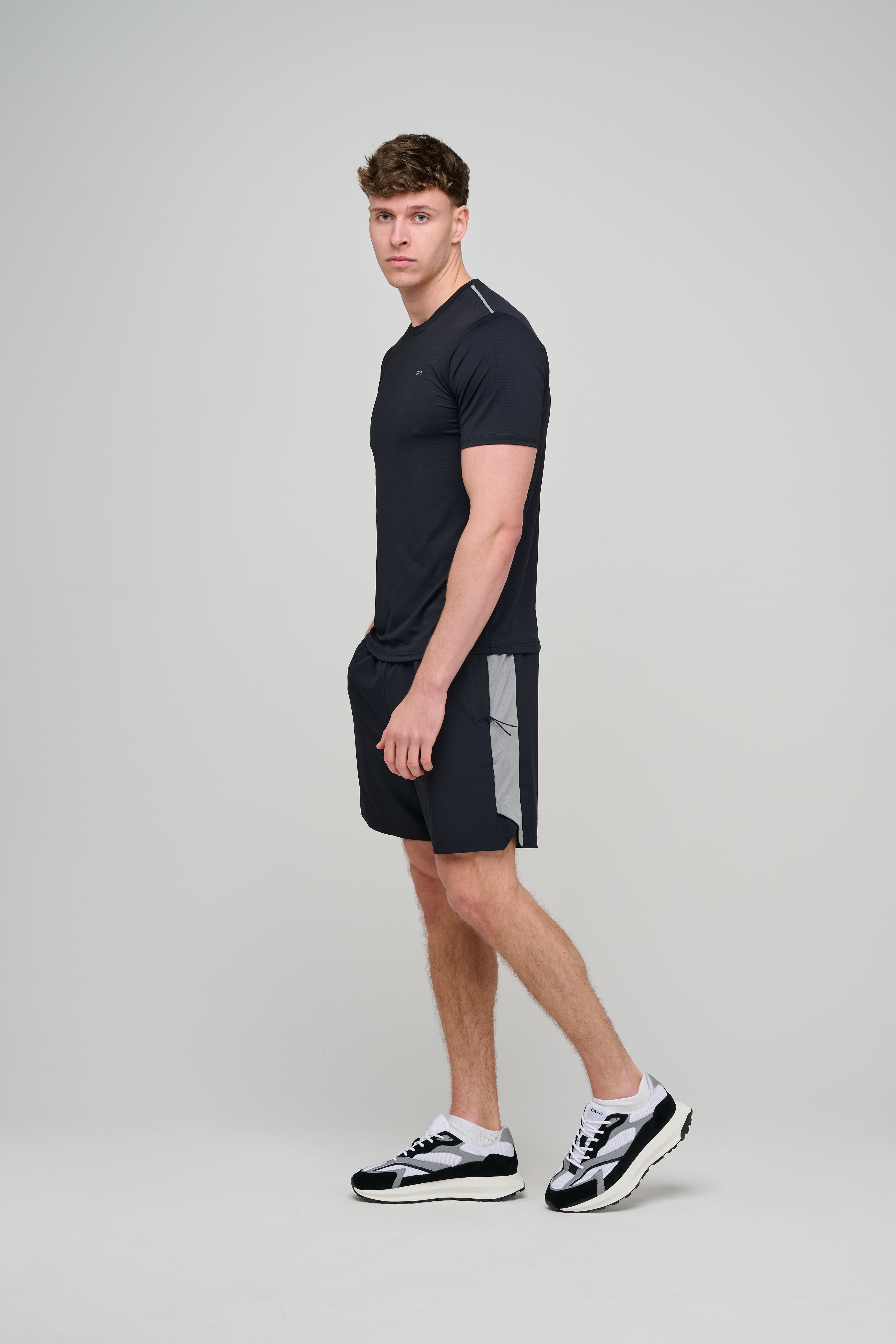 Side view of CAPO Active Performance Black Shorts