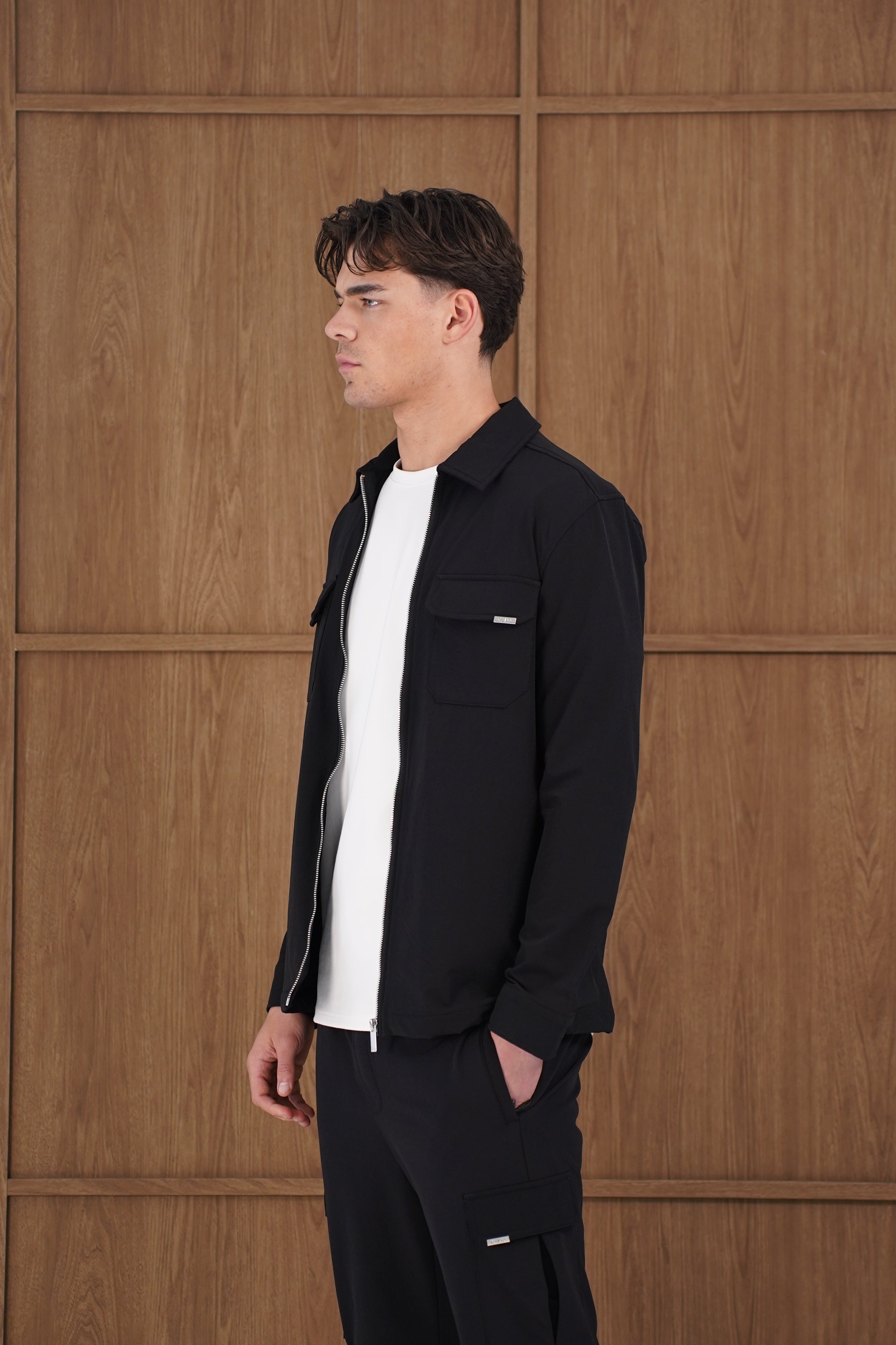 Model side view of CAPO Utility Black Overshirt