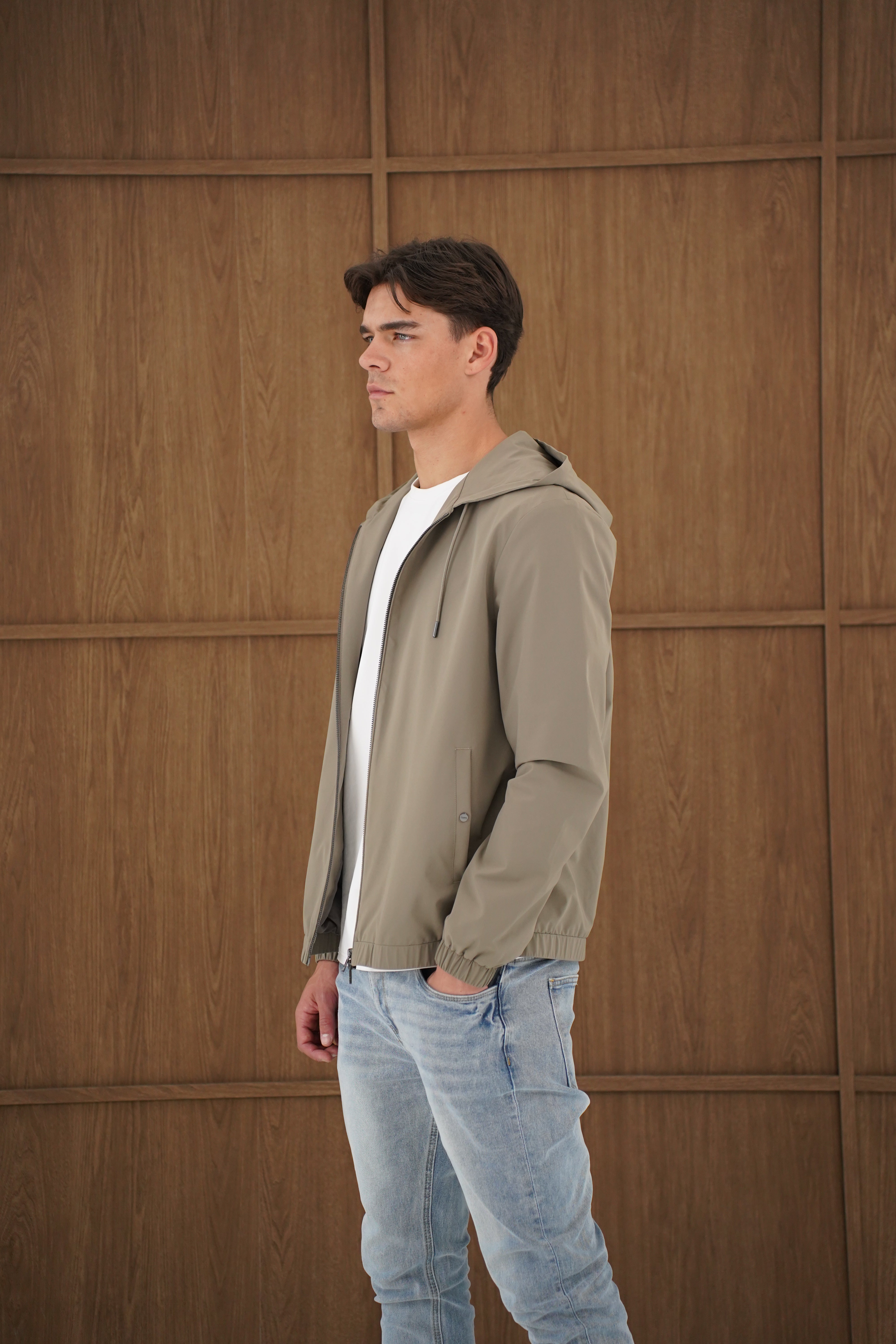 Model side view of CAPO Lightweight Shell Olive Jacket 