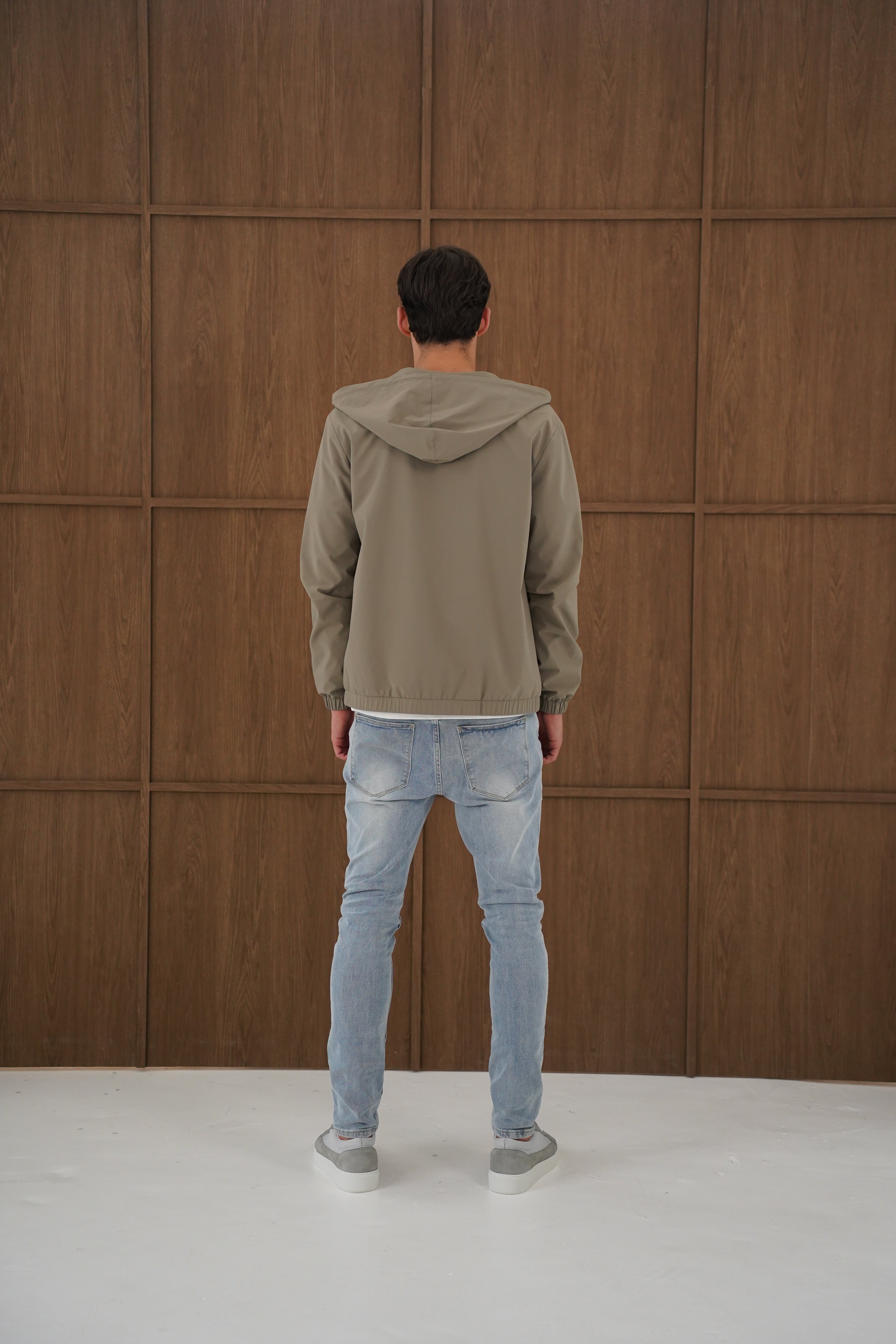 Model back view of CAPO Lightweight Shell Olive Jacket