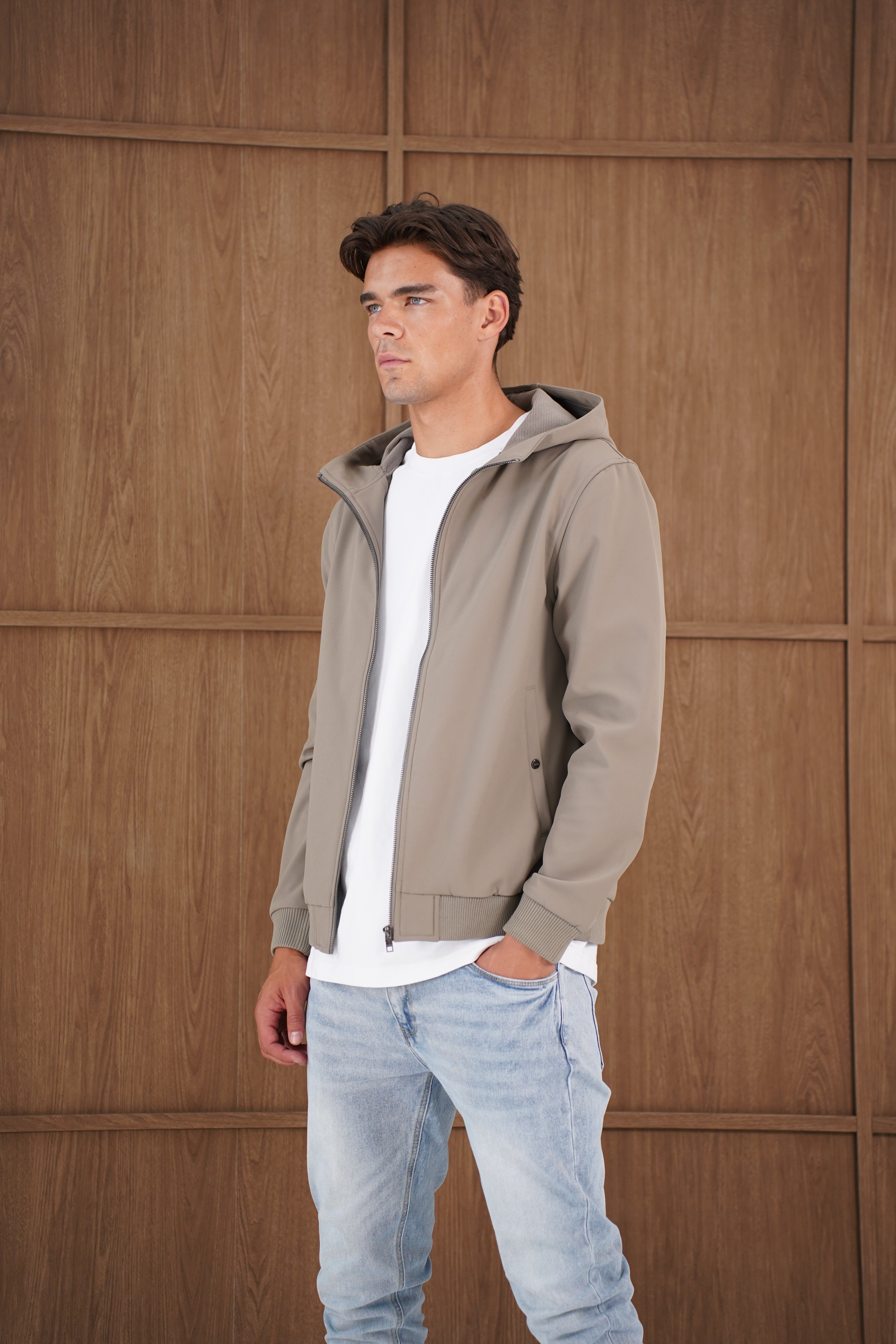 Model side view of CAPO Soft Shell Hood Olive Jacket