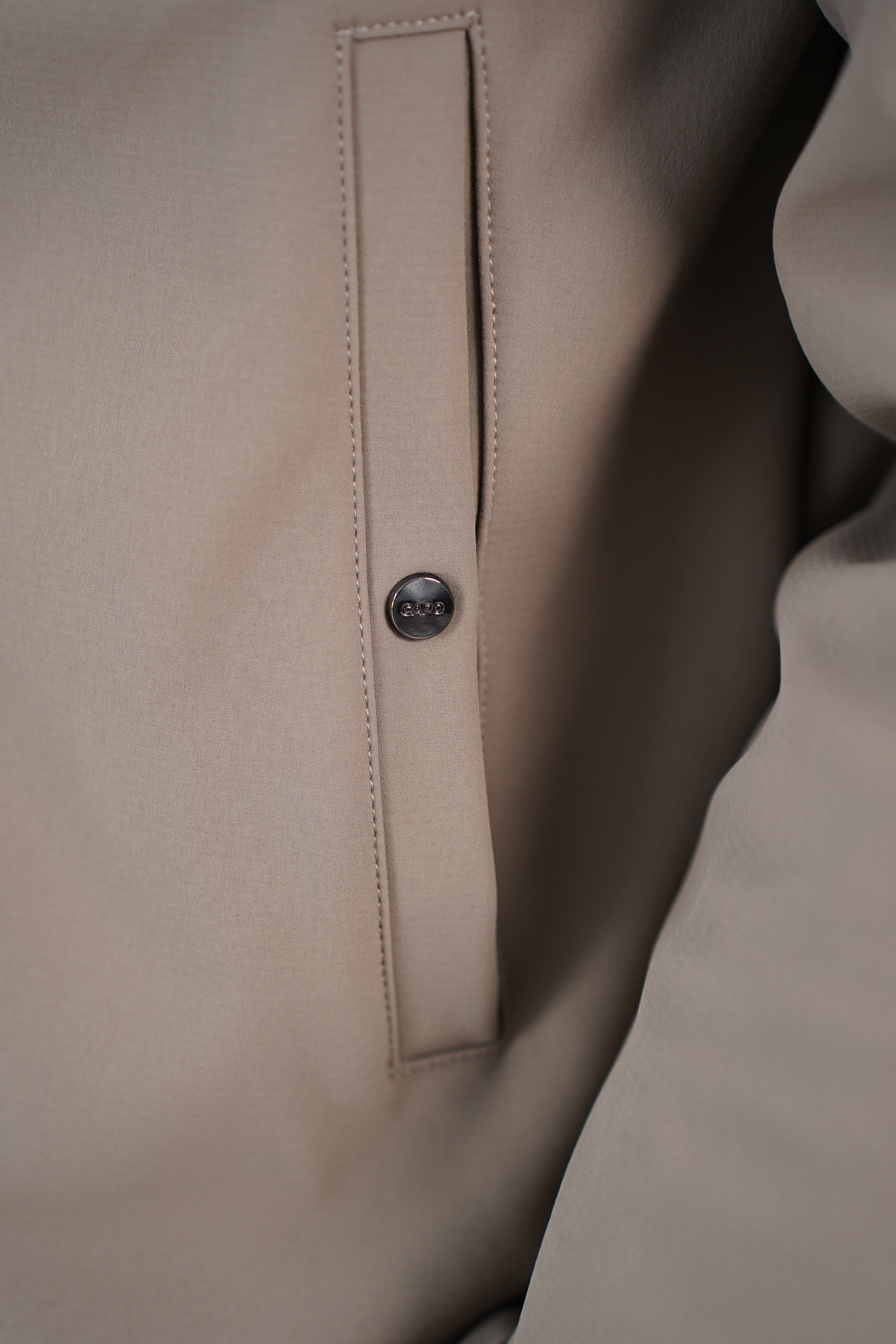Pocket detail view of CAPO Soft Shell Hood Olive Jacket