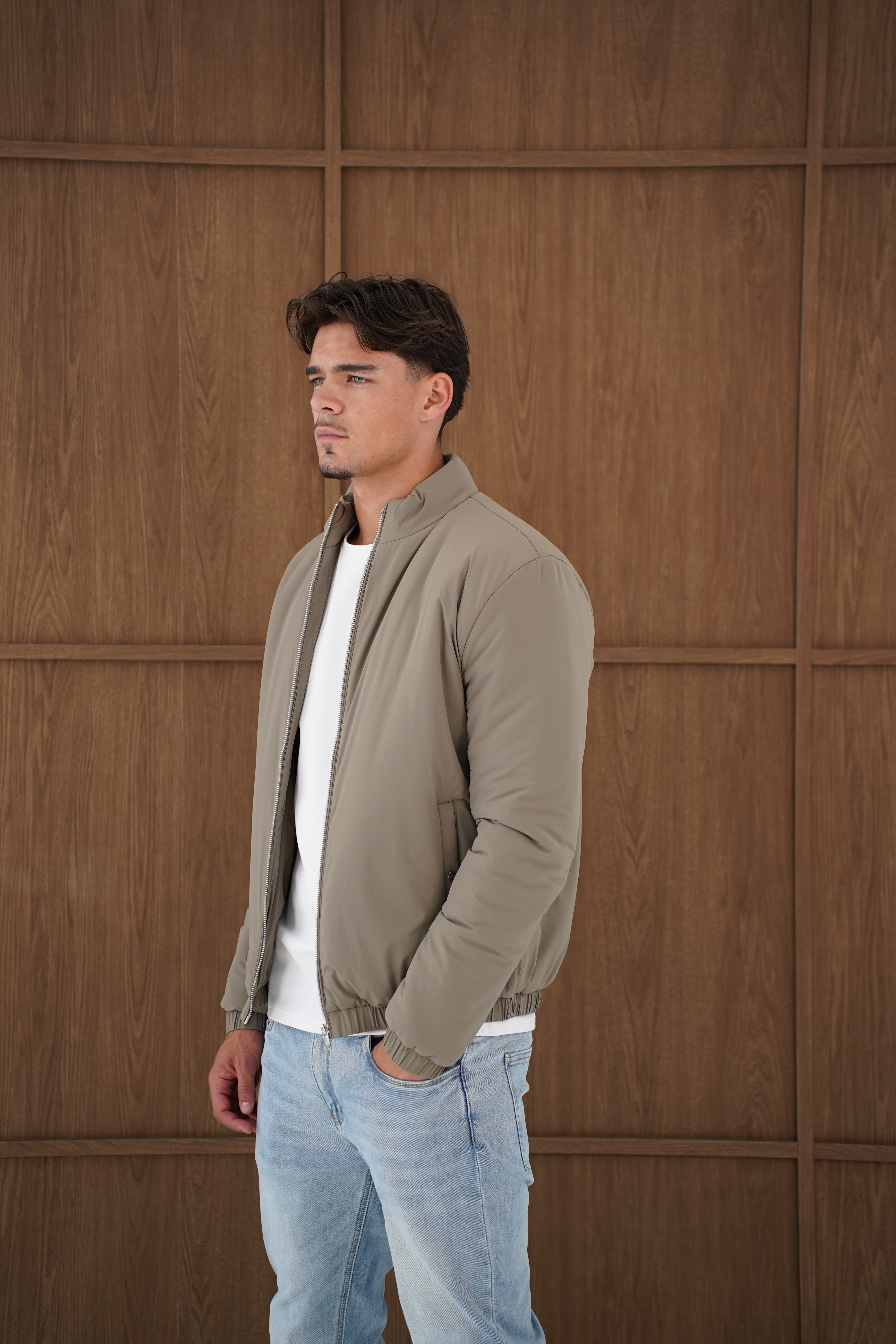 Model side view of CAPO Padded Olive Bomber Jackets