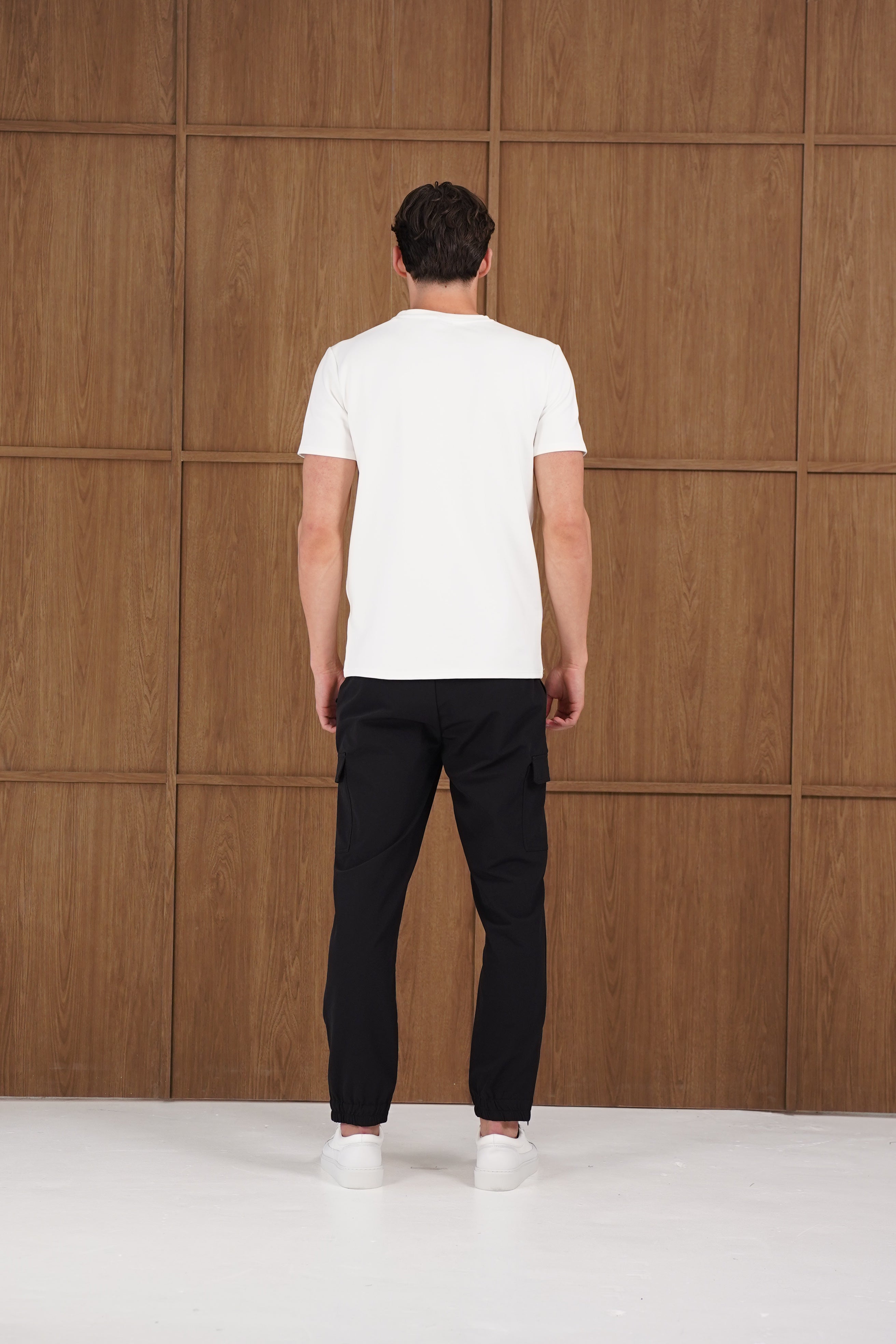 Model back view of CAPO Smart Cuffed Black Cargo Pants
