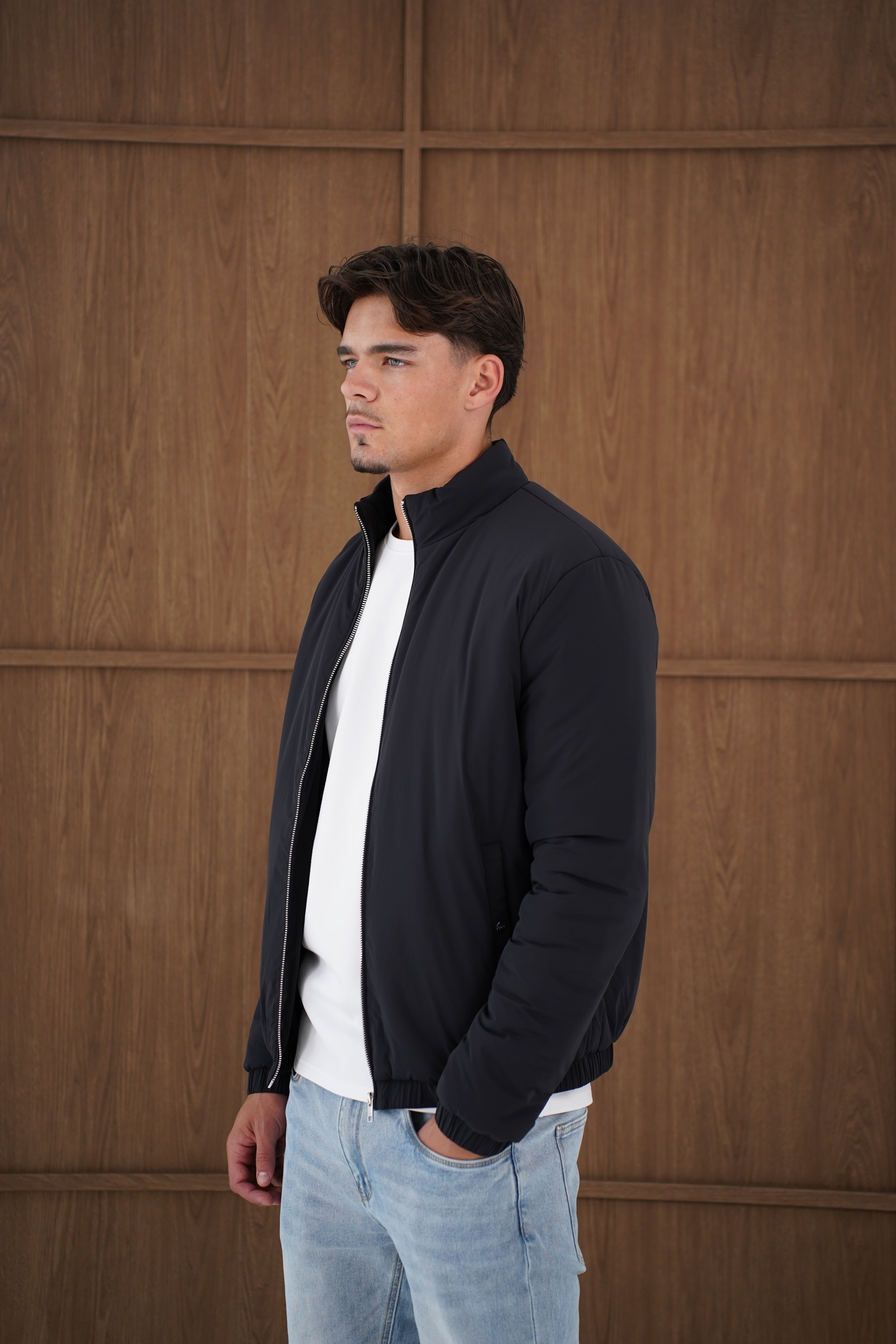 Model side view of CAPO Padded Bomber Black Jacket