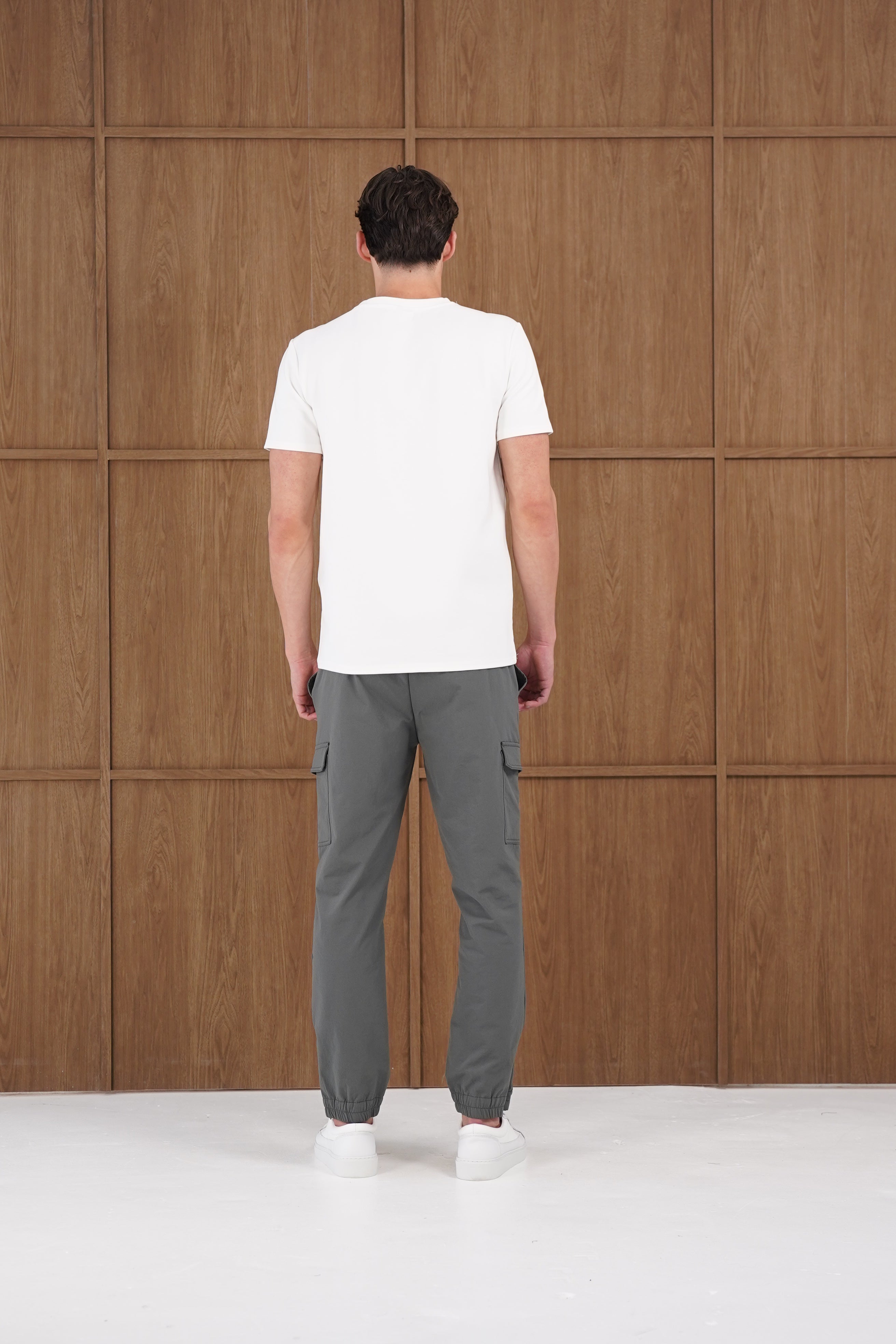 Model back view of CAPO Smart Cuffed Charcoal Cargo Pants