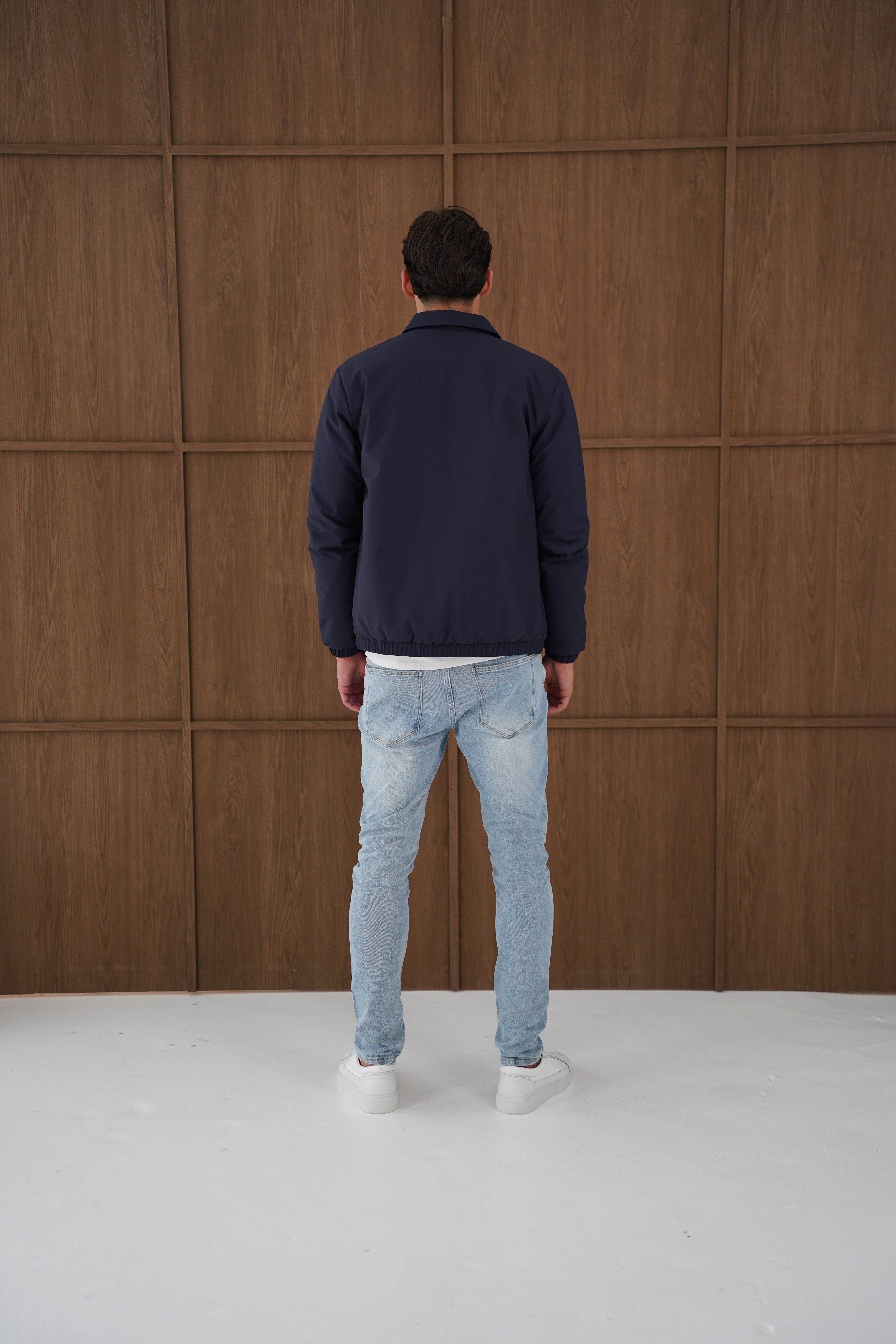 Model back view of CAPO Padded Collar Navy Jacket