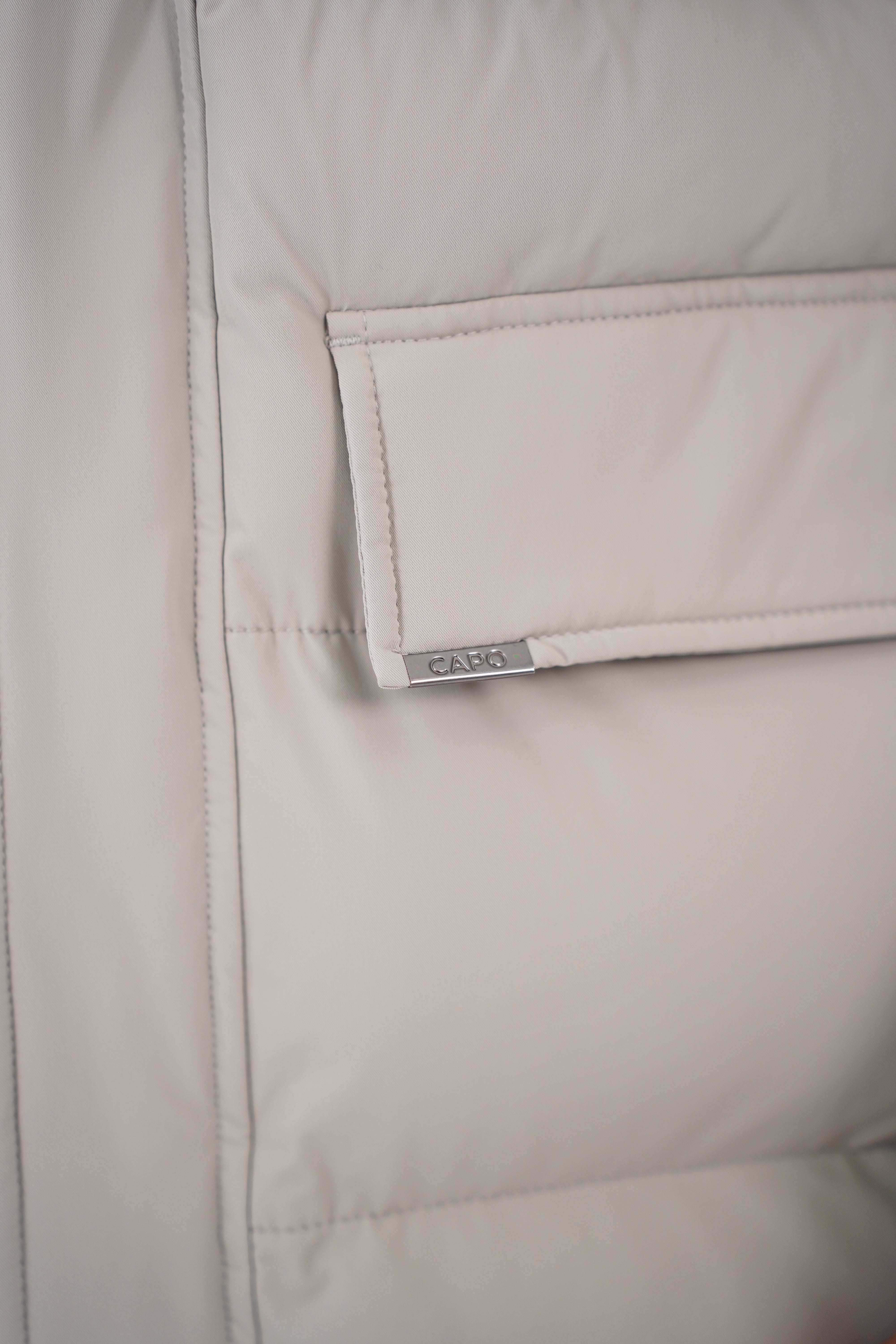 Detail pocket view of CAPO Mid Length Stone Puffer Jacket