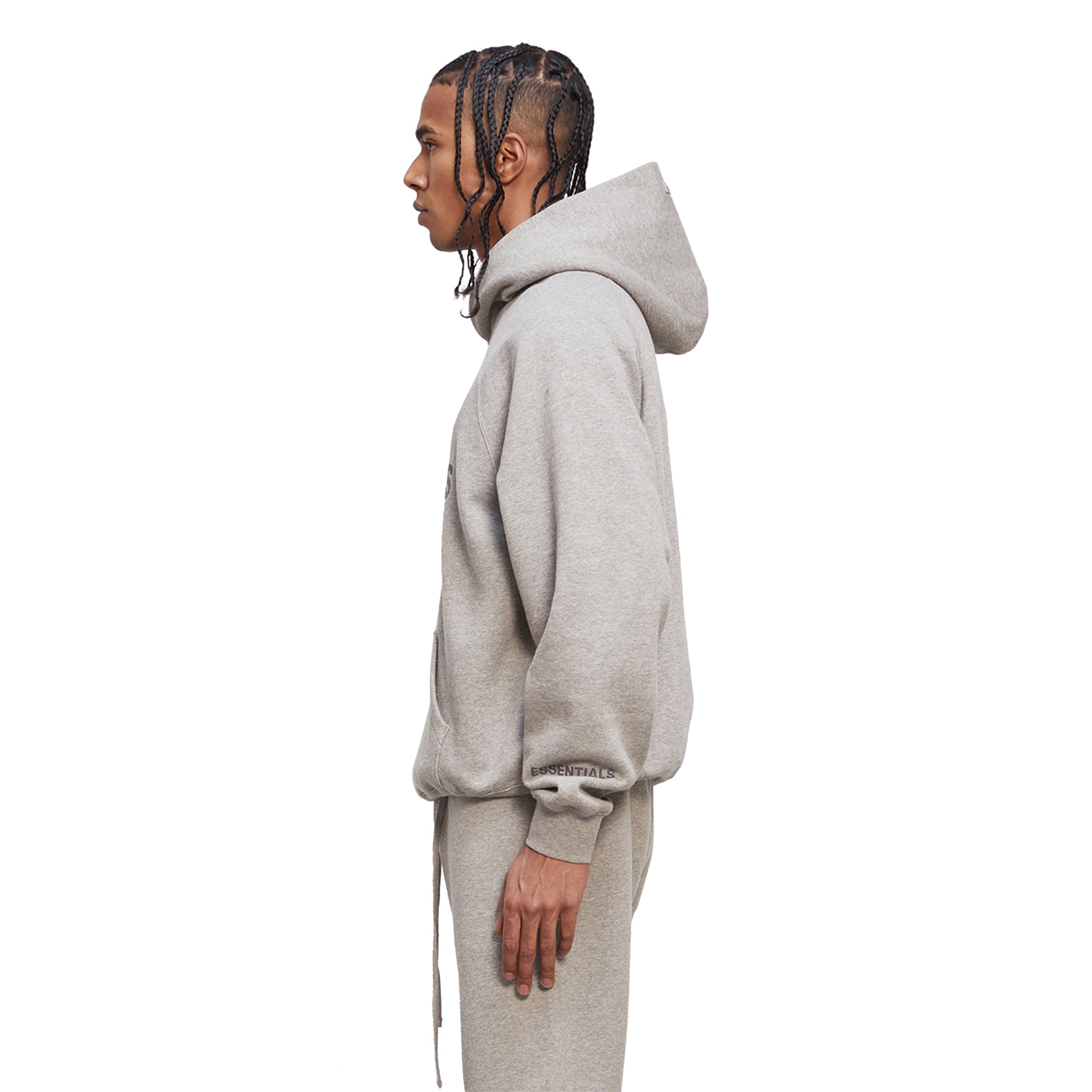 Model sid back view of Fear Of God Essentials Heather Oatmeal Hoodie