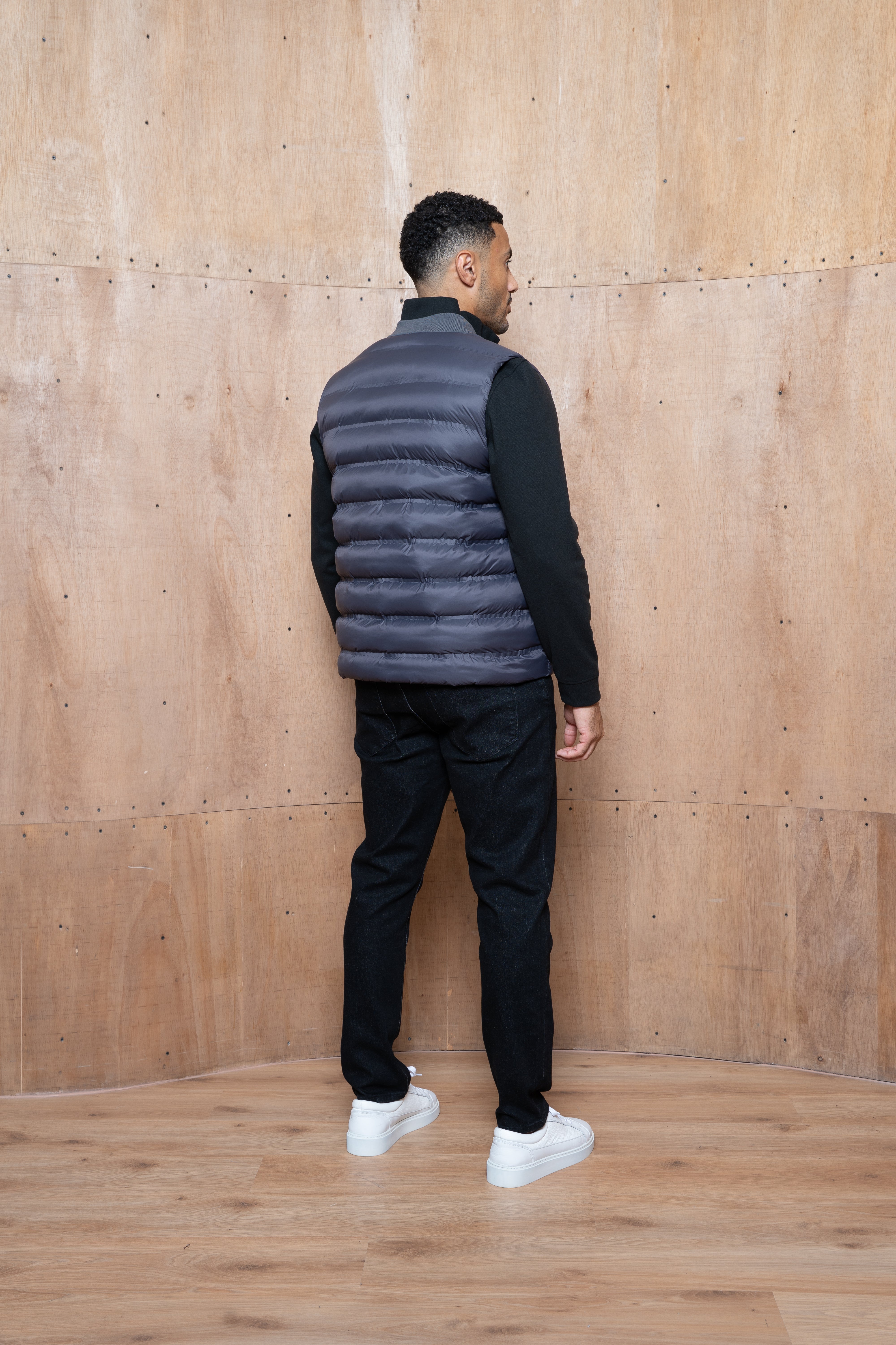 Model back view of CAPO Tech Asphalt Puffer Gilet