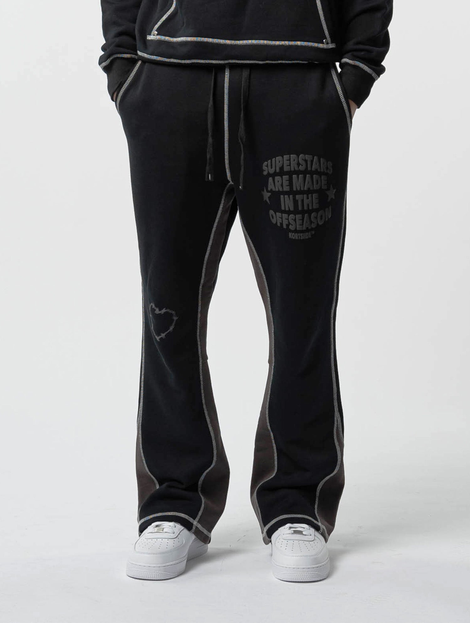 Front model view of kortsiide Superstar Stitched Flared Triple Black Sweatpants