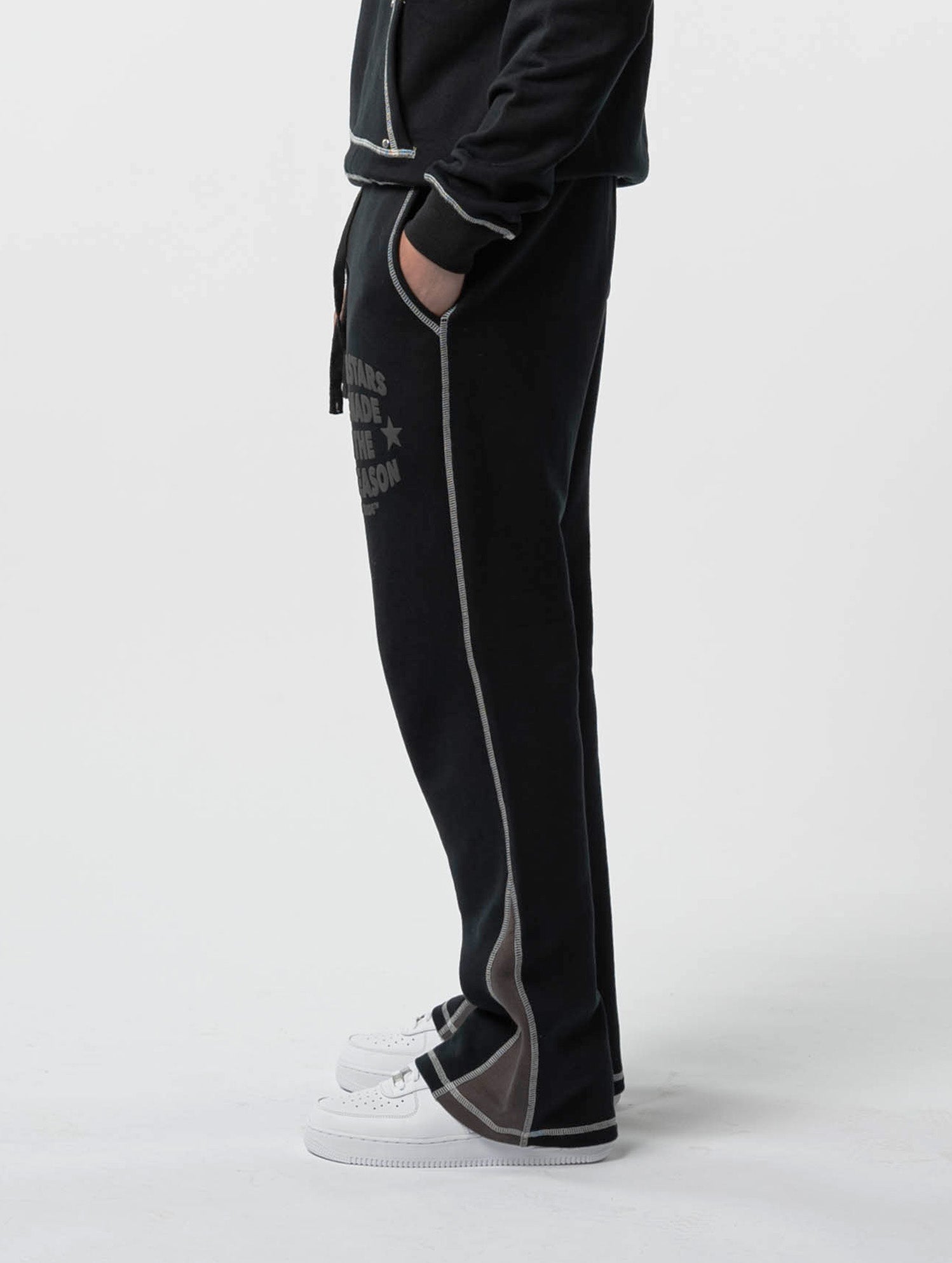 Model Side view of kortsiide Superstar Stitched Flared Triple Black Sweatpants