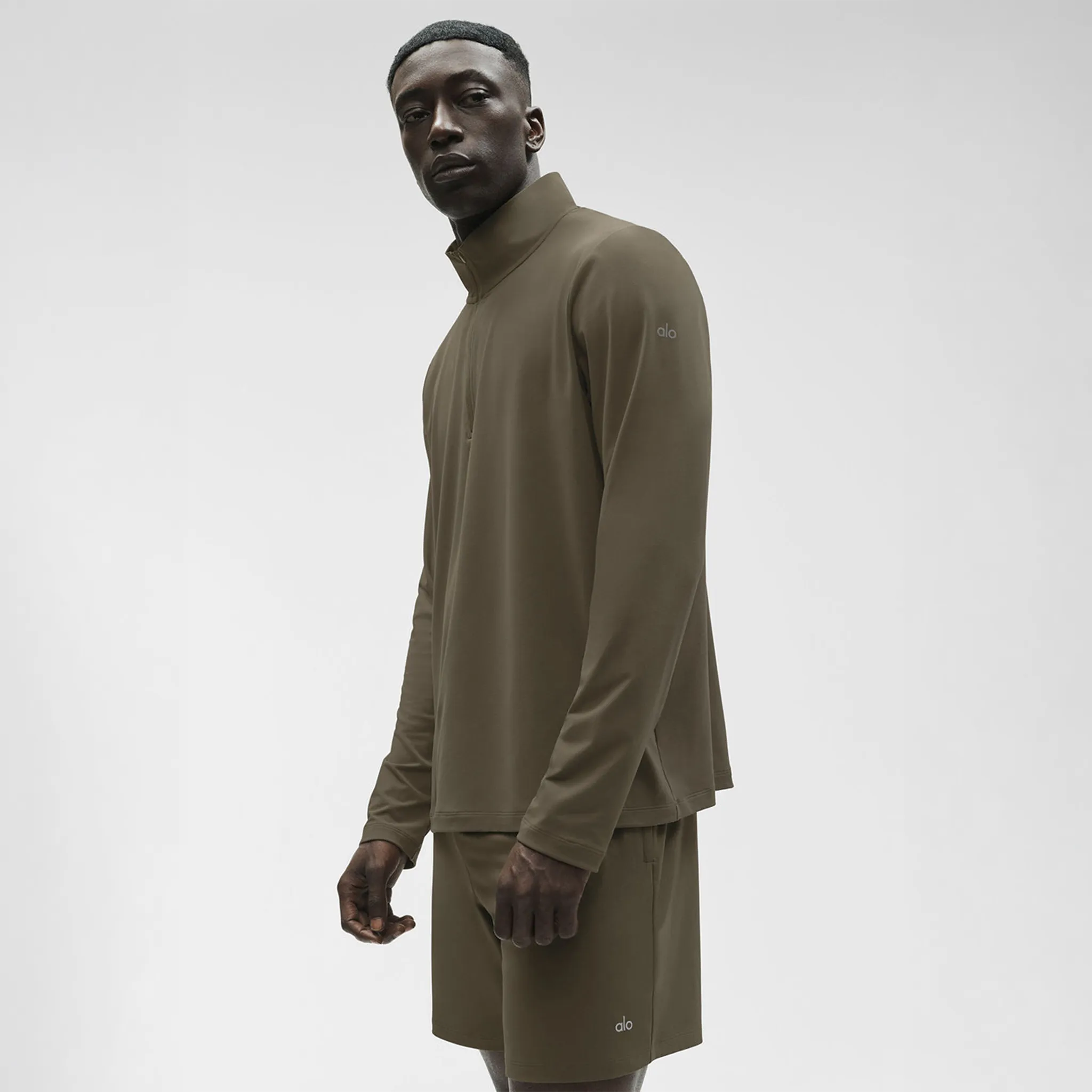 Front Side View of Alo Yoga Conquer Reform Olive Tree L/S 1/4 Zip