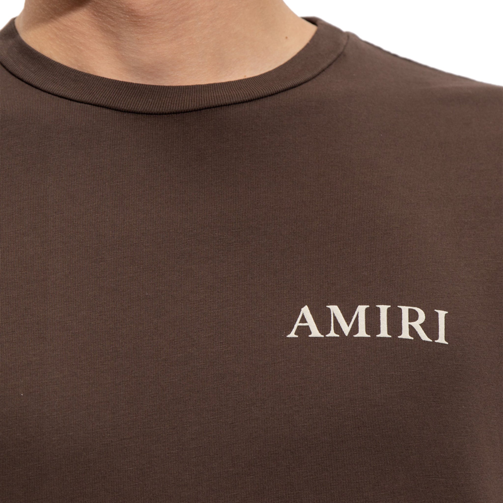 Model chest view of Amiri Puff Logo T Shirt Brown AW22MJL010-210