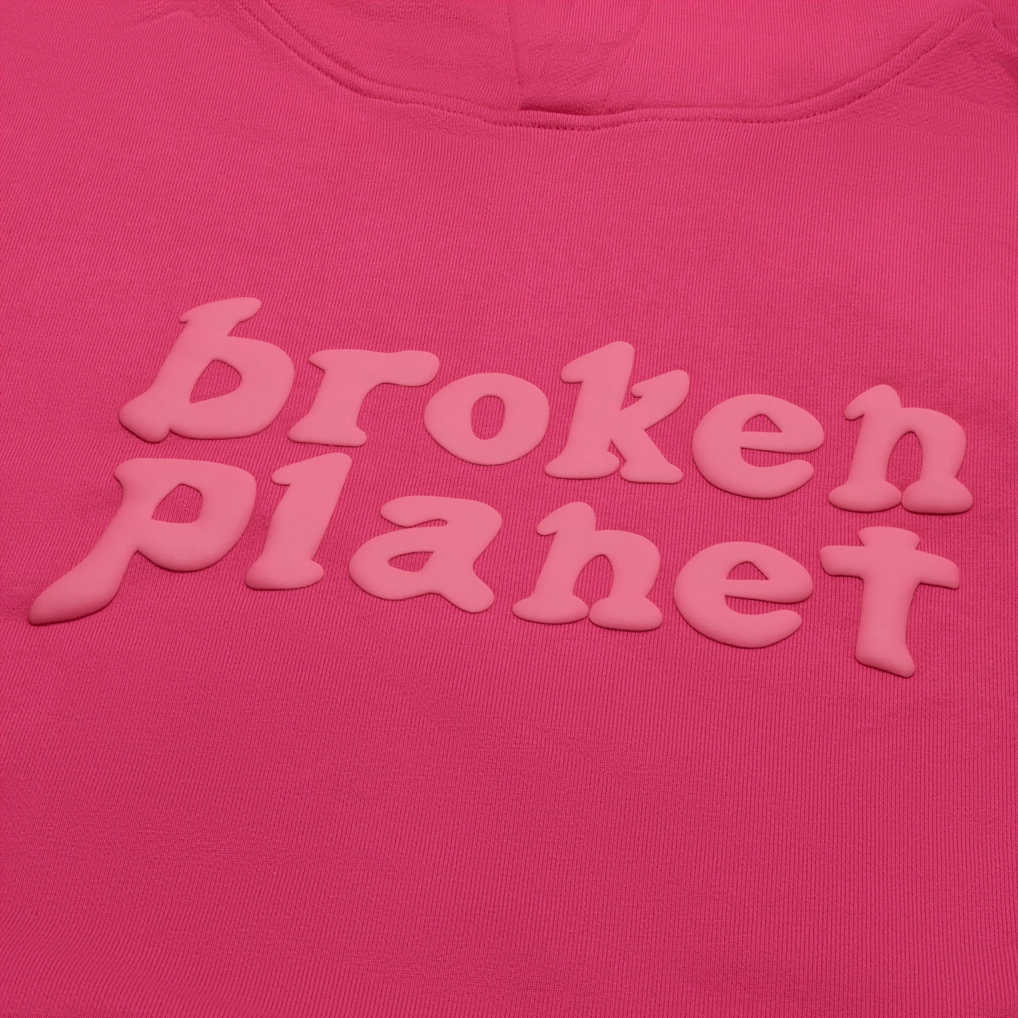 Front logo view of Broken Planet Monochrome Fuchsia Pink Hoodie