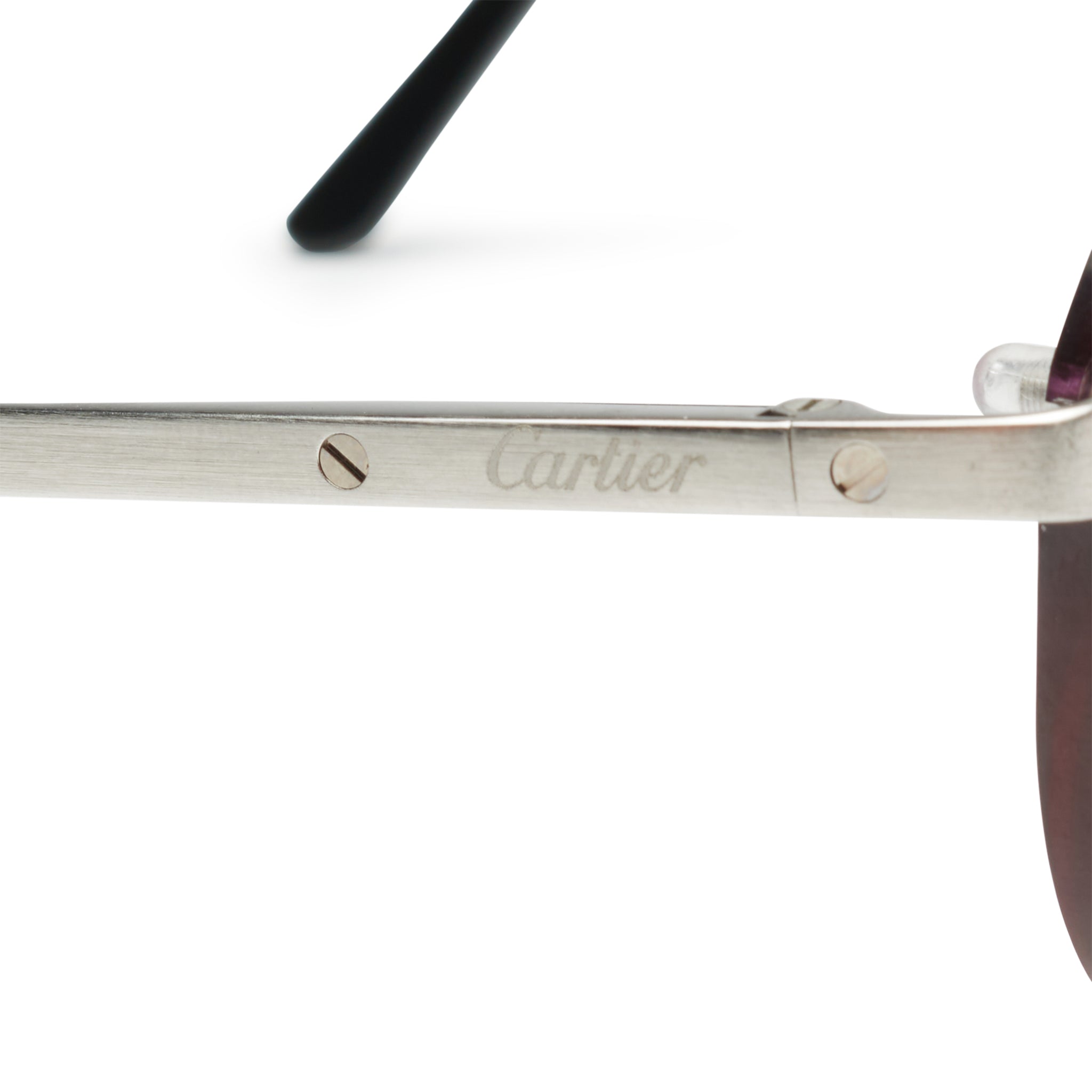 Screw detail view of Cartier Eyewear Custom CT0167O-002 Santos De Cartier Rimless Sunglasses
