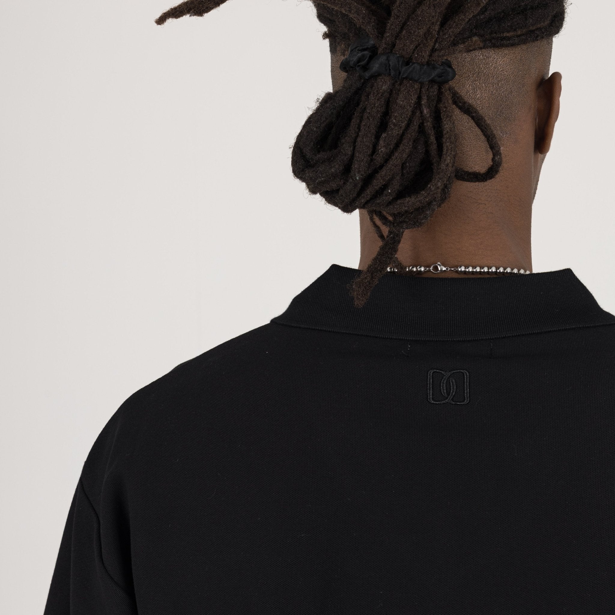 Detail view of Destructive Cropped Black Polo Shirt