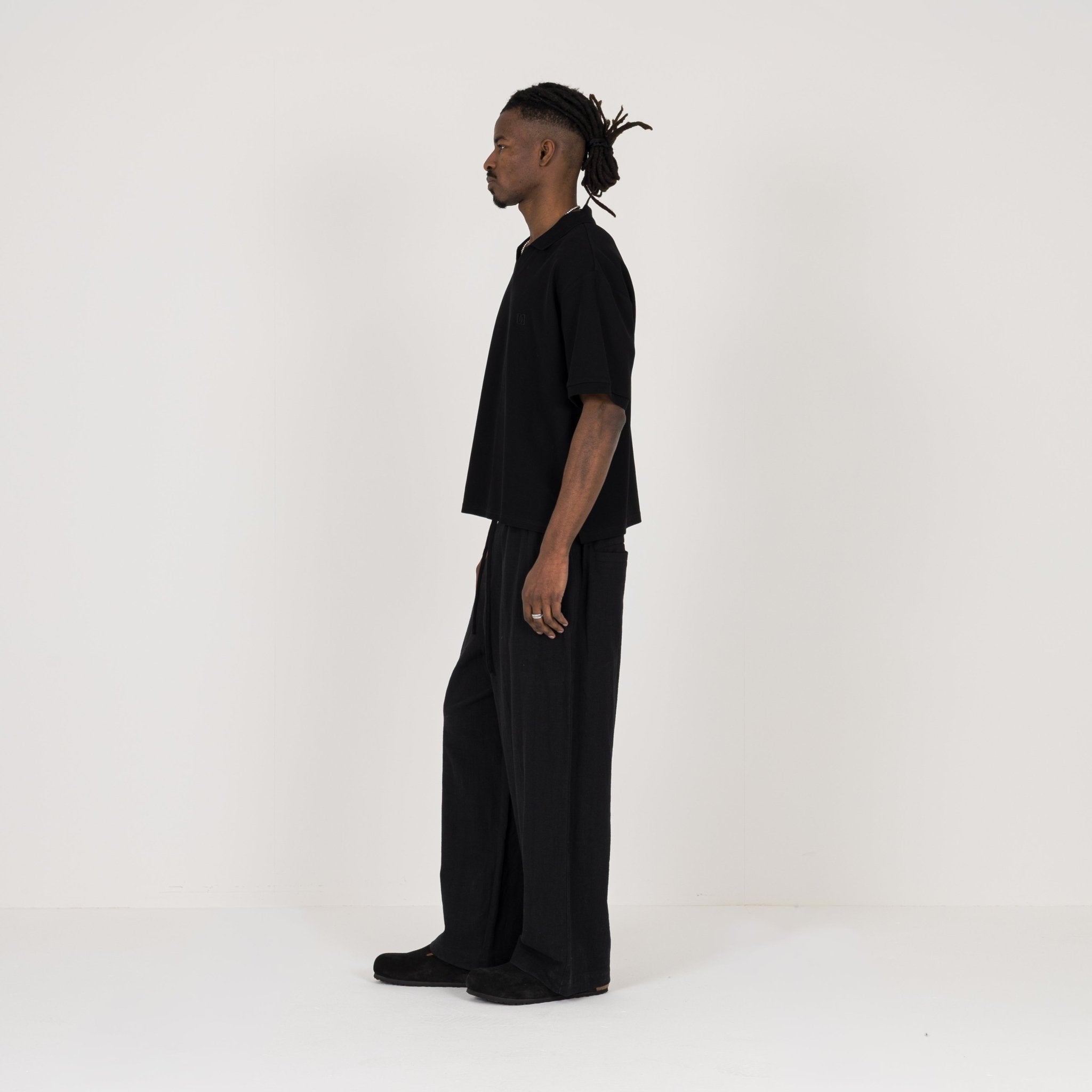 Model Side view of Destructive Cropped Black Polo Shirt