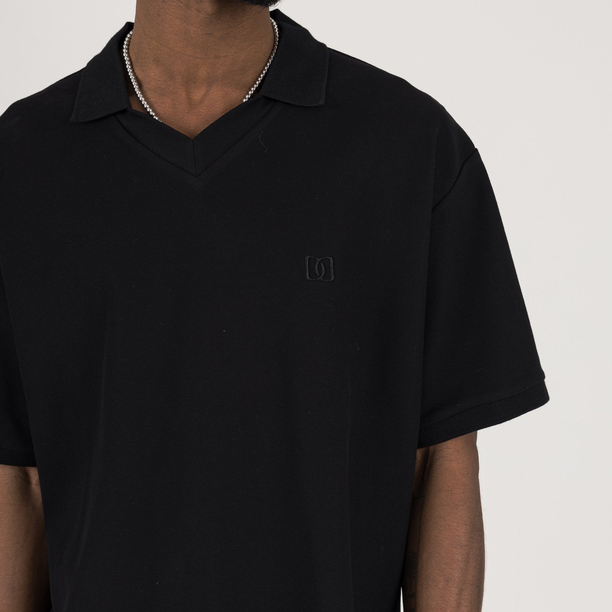 Detail view of Destructive Cropped Black Polo Shirt