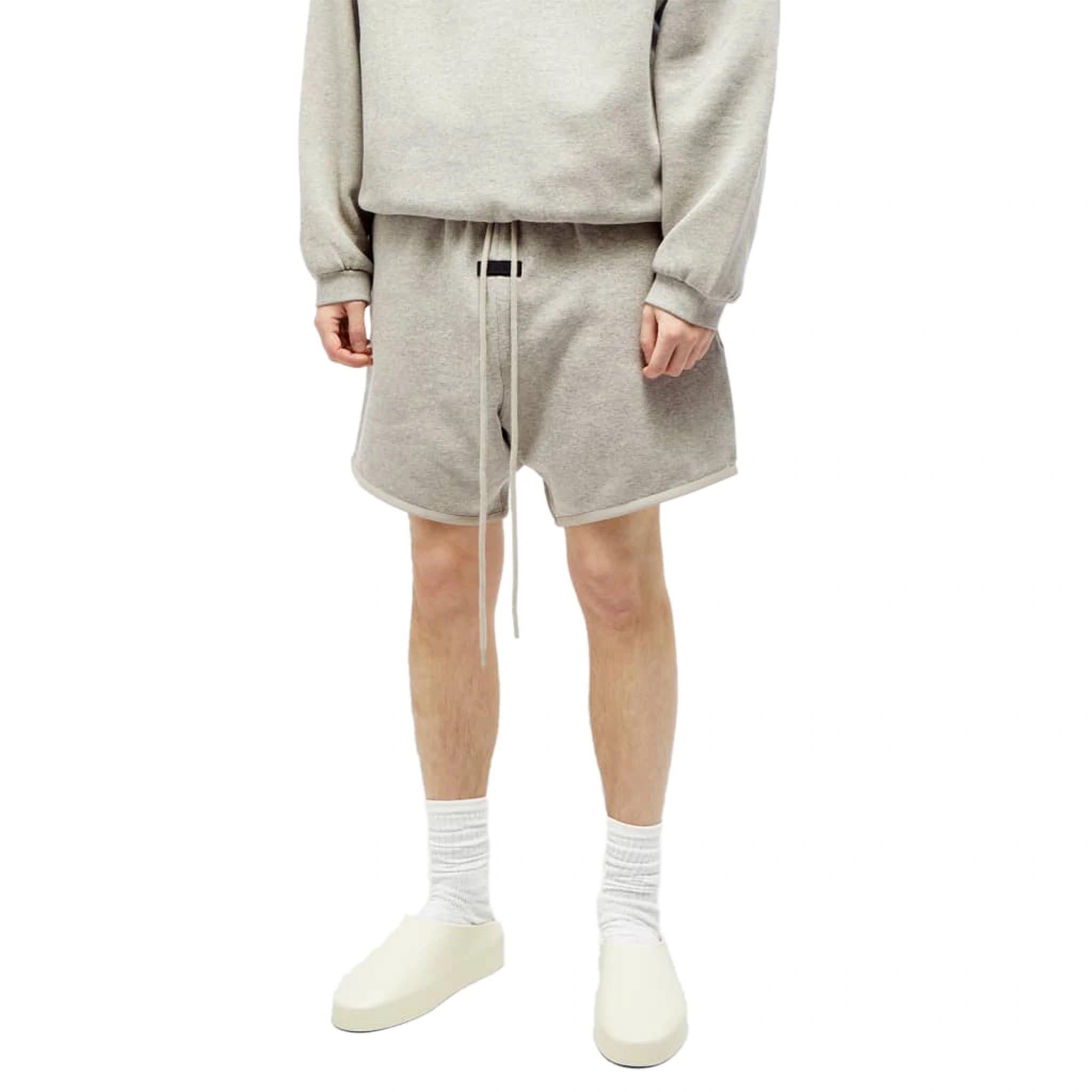 Model front view of Fear Of God Essentials Dark Heather Oatmeal Shorts (FW23) 160SP242003F