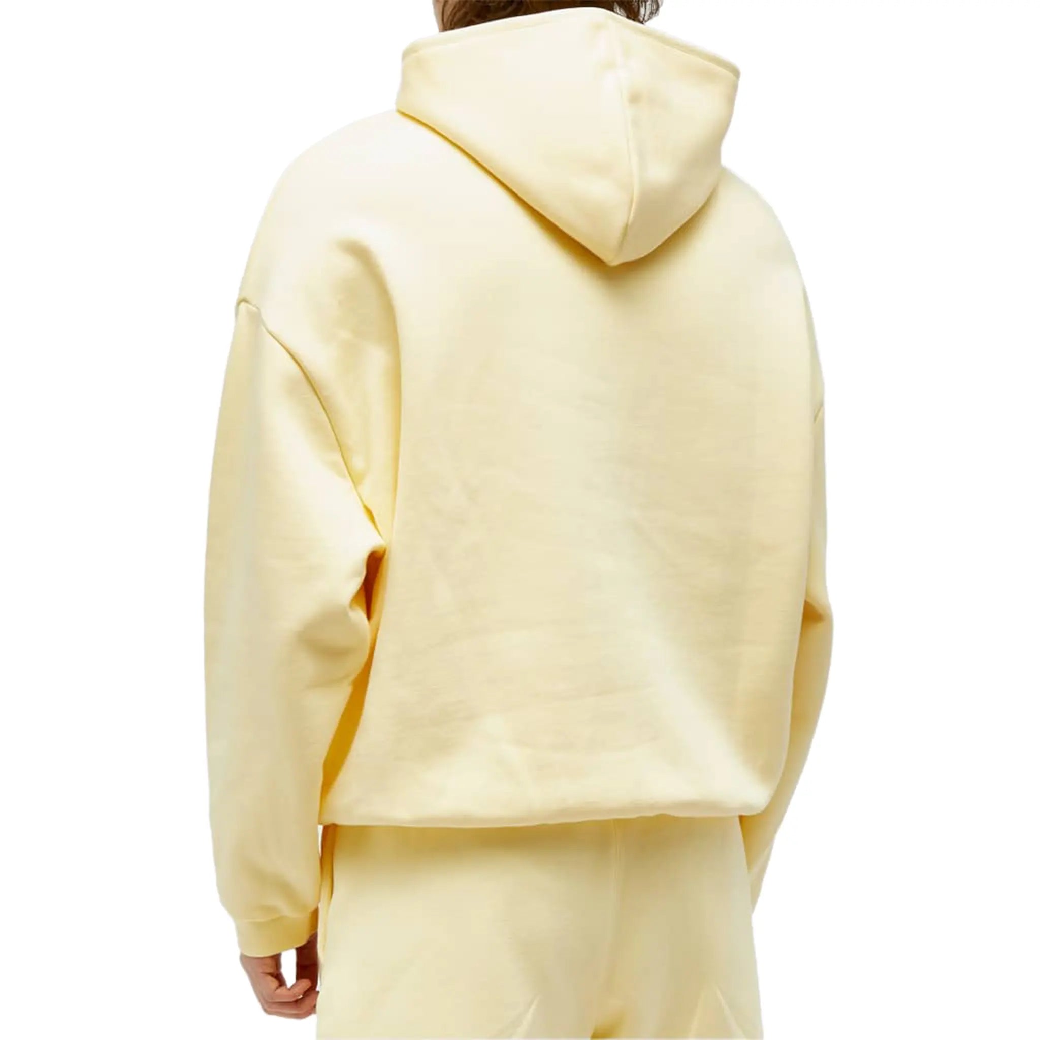Model back view of Fear Of God Essentials Garden Yellow Hoodie (FW23) 192SP242051F